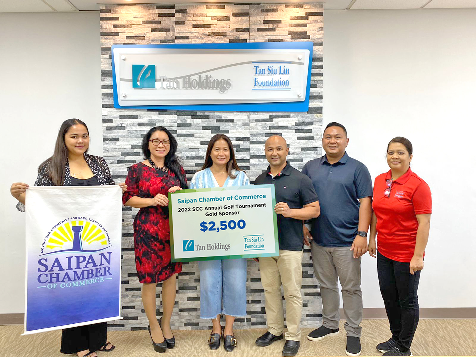 Saipan Chamber of Commerce officers led by president Joe Guerrero, fourth left, receive the a ceremonial check donation for the 2022 SSC Annual Golf Tournament from Tan Siu Lin Foundation executive director Merlie Tolentino, third left.