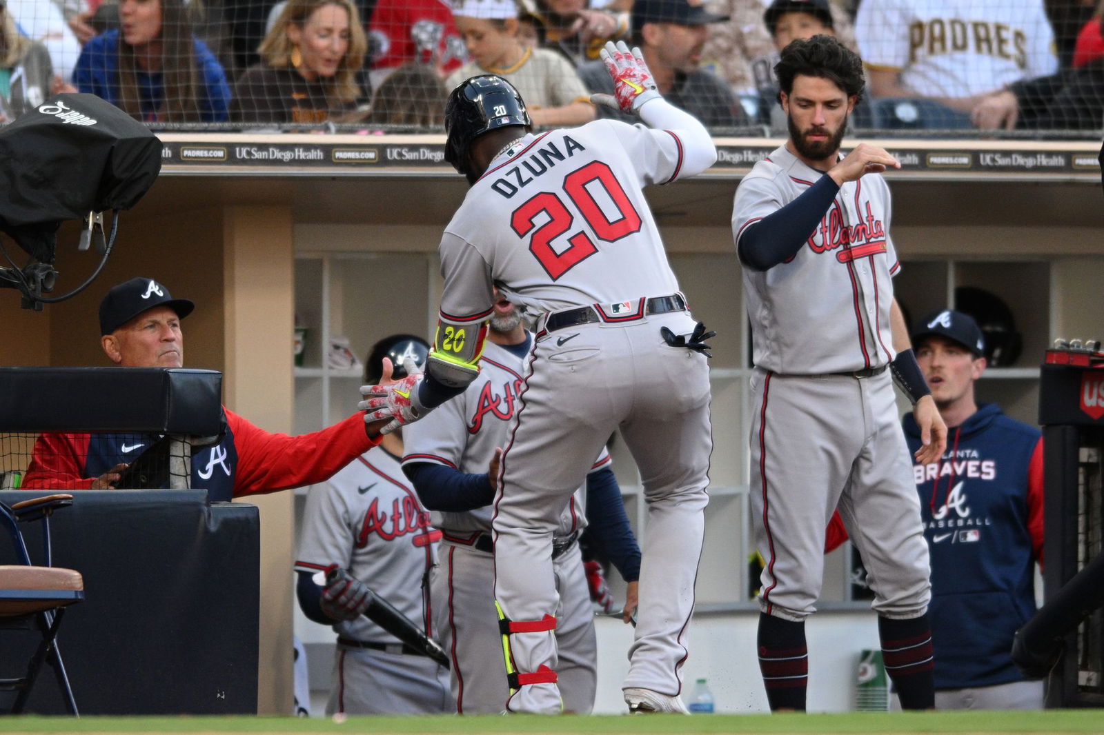 Atlanta Braves left fielder Marcell Ozuna (20) is congratulated by manager Brian Snitker (left) after hitting a home run against the San Diego Padres during the seventh inning at Petco Park in San Diego, California, April 17, 2022.