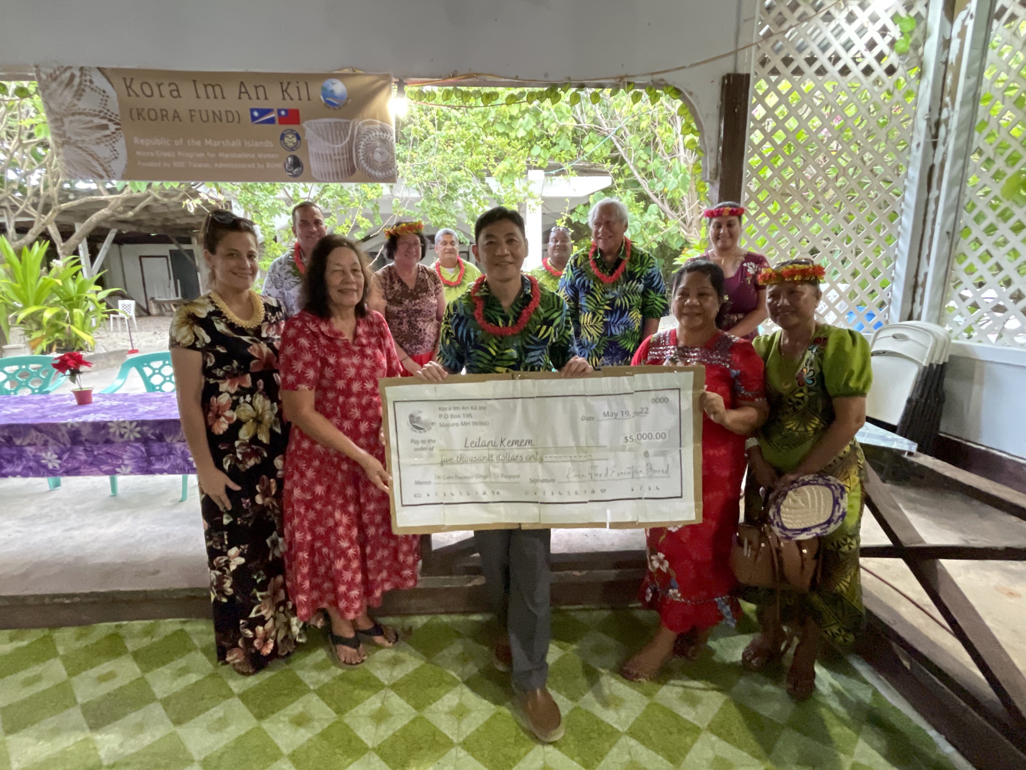 Ebeye resident Leilani Kemem, second from right front, receives the first loan at a ceremony earlier this month on Ebeye. Delivering the $5,000 business loan are Kora Fund Chair Amenta Matthew and Taiwan Embassy Deputy Chief of Mission Mars Wang.