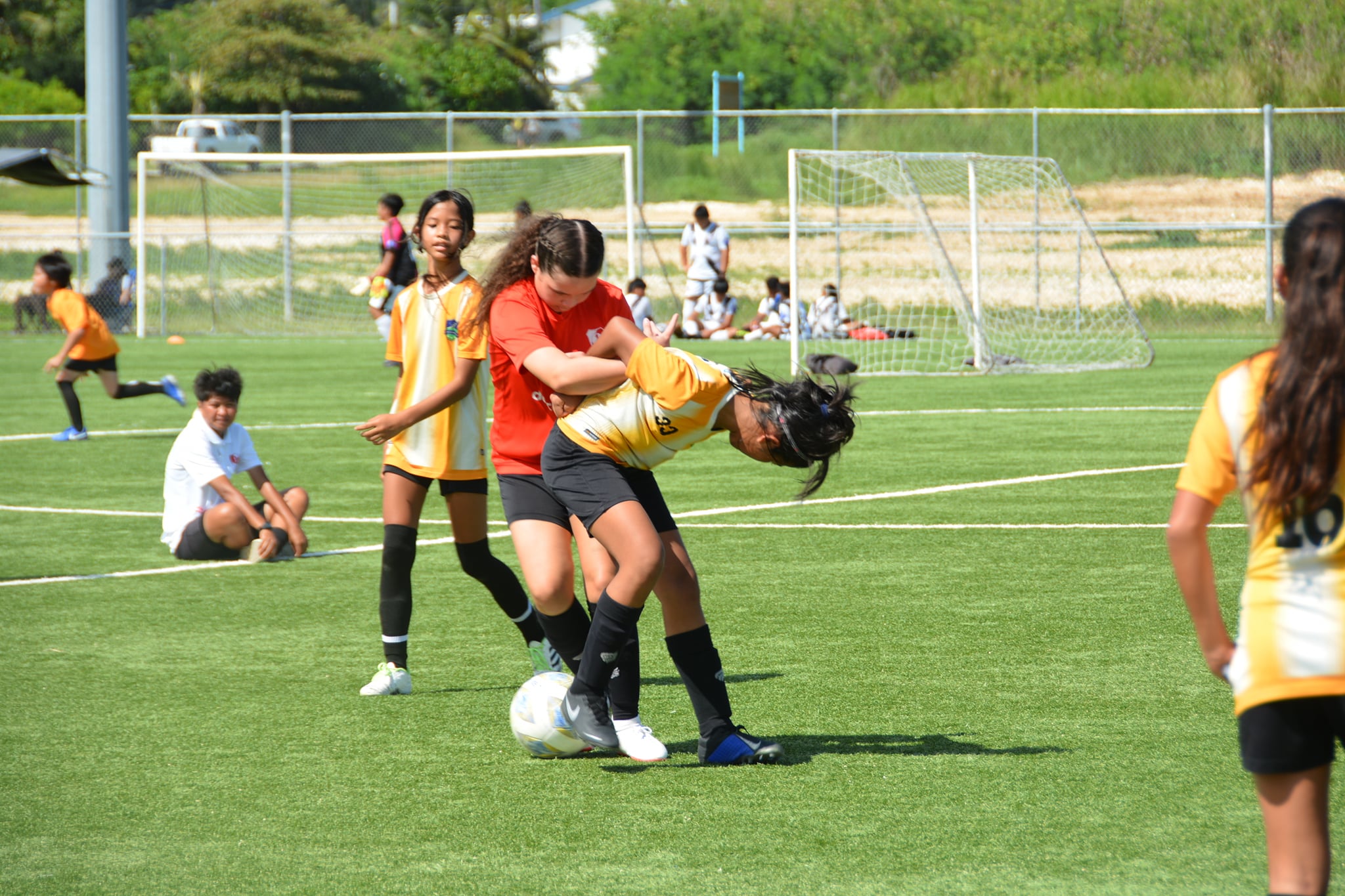 Kanoa 1's Ha Ye and a Paire player battle for the possession during a  U13 girls division game of the TakeCare Youth Soccer League at the NMI Soccer Training Center on Saturday.
