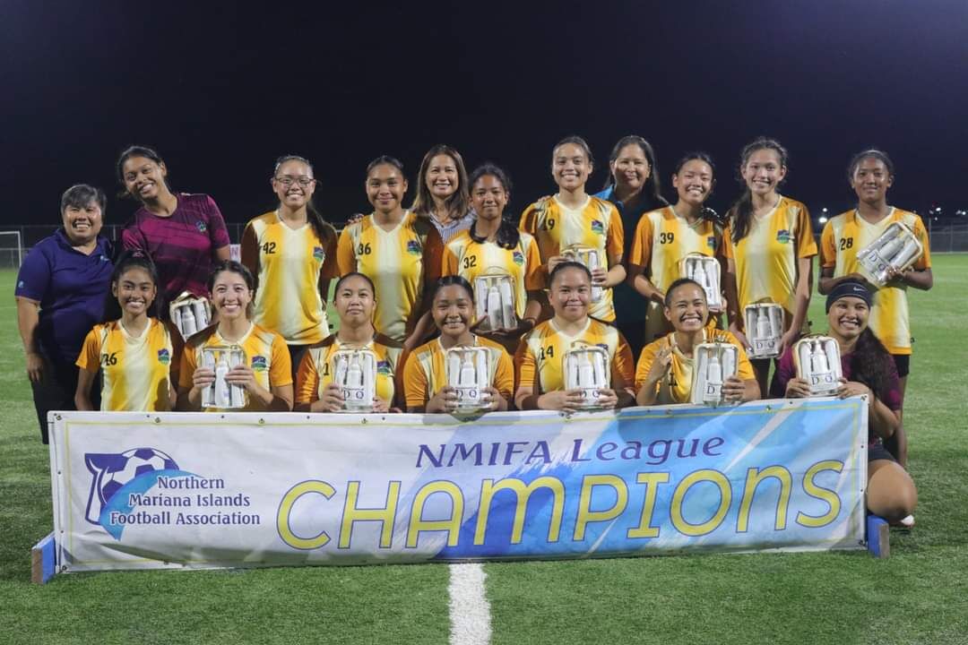Kanoa Football Club players pose with the Premier Division  championship trophy of the Dove Women's League at the NMI Soccer Training Center.