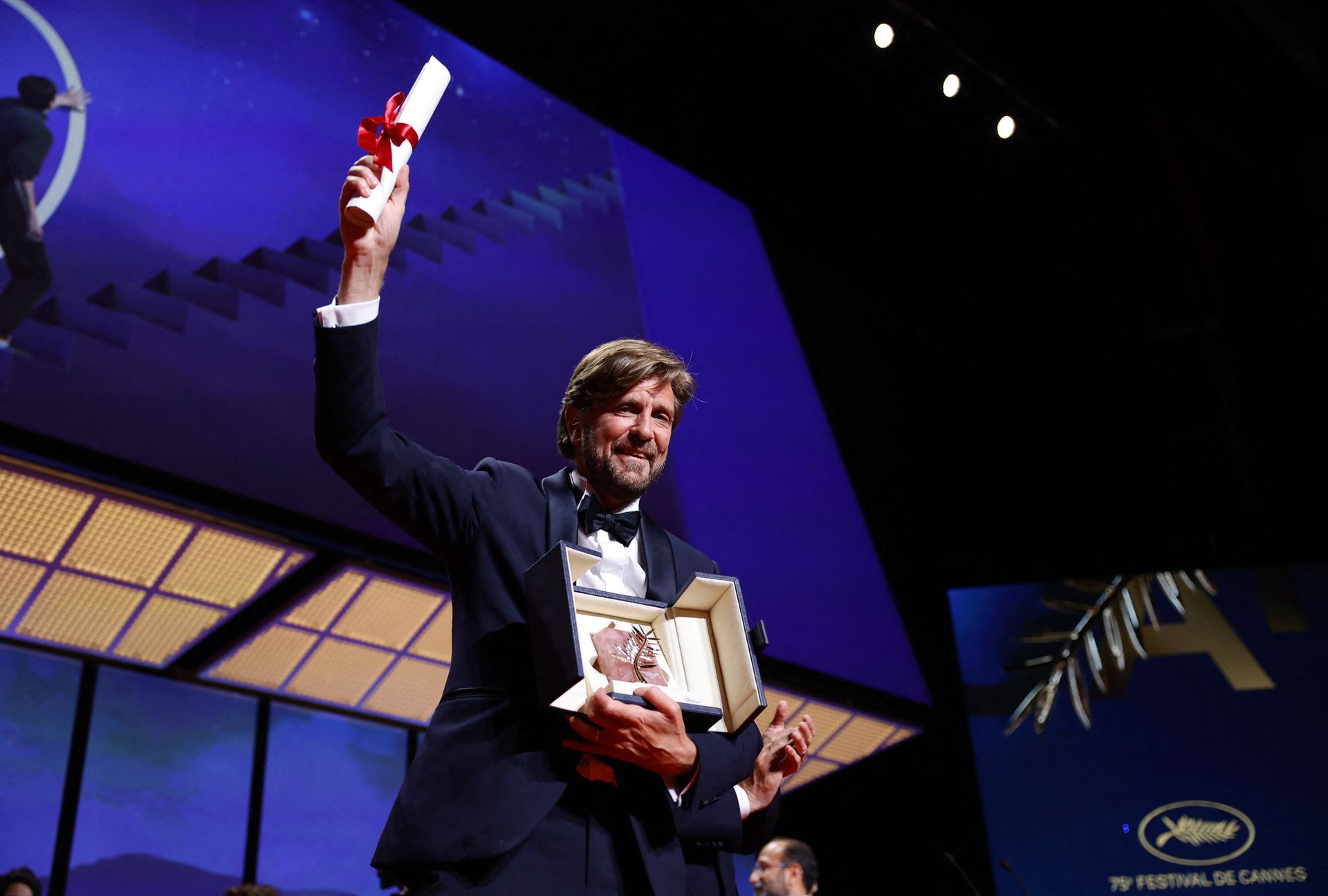 Director Ruben Ostlund, Palme d'Or award winner for the  film "Triangle of Sadness" poses on stage during the closing ceremony of the 75th Cannes Film Festival in Cannes, France, May 28, 2022.