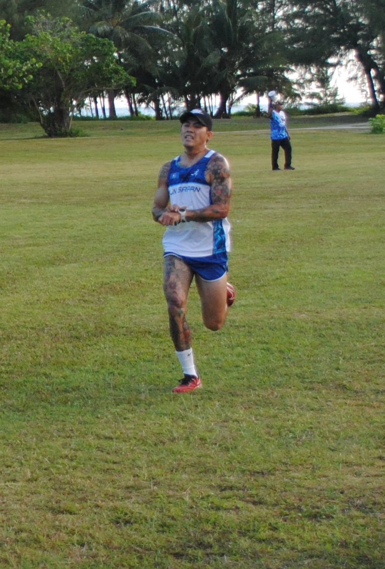 Michael Mancao crosses the finish line of the 2nd CNMI Star Wars Day Run on Saturday morning at American Memorial Park.