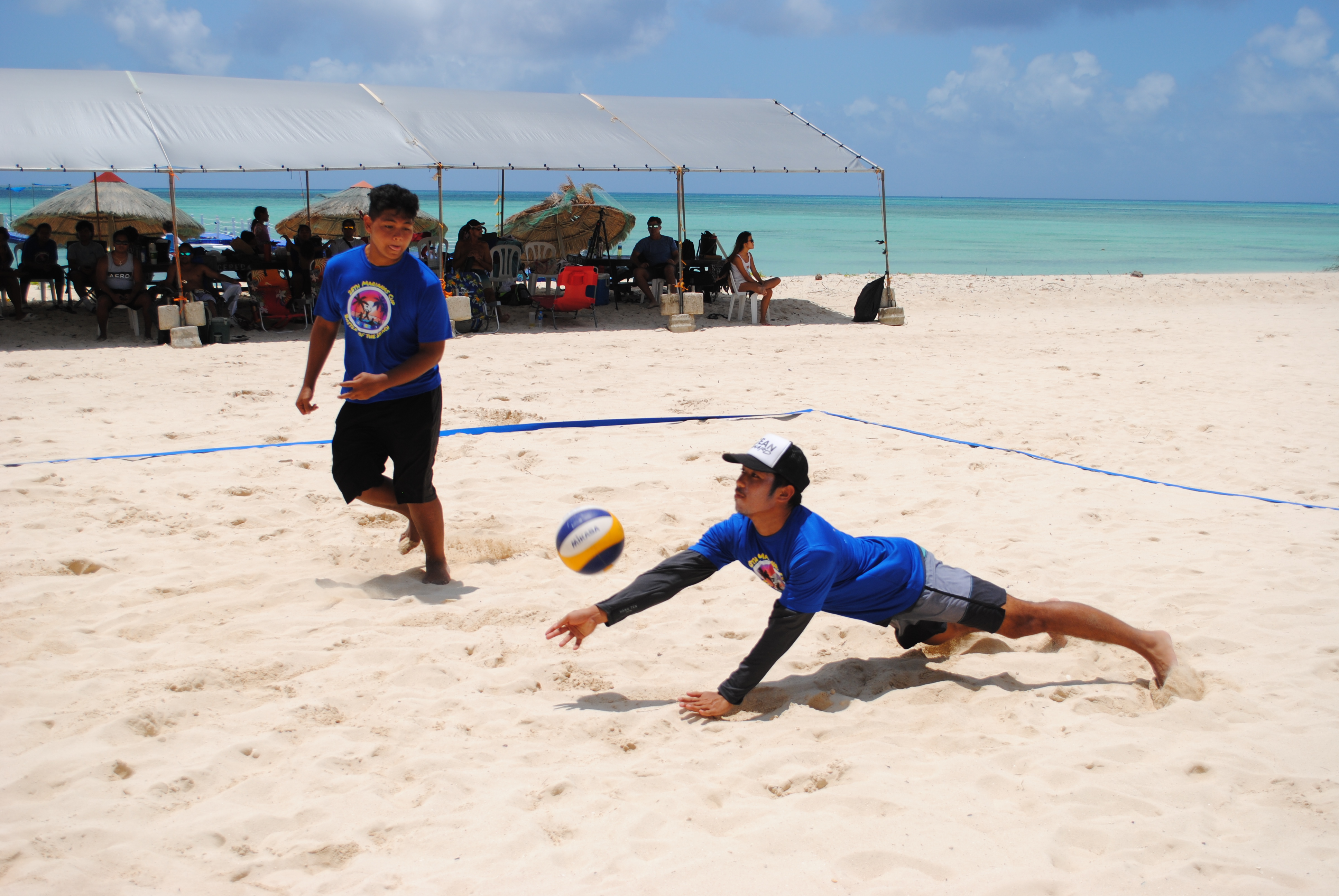 Tony Atalig dives to save the possession as teammate Damian Palacios looks on.