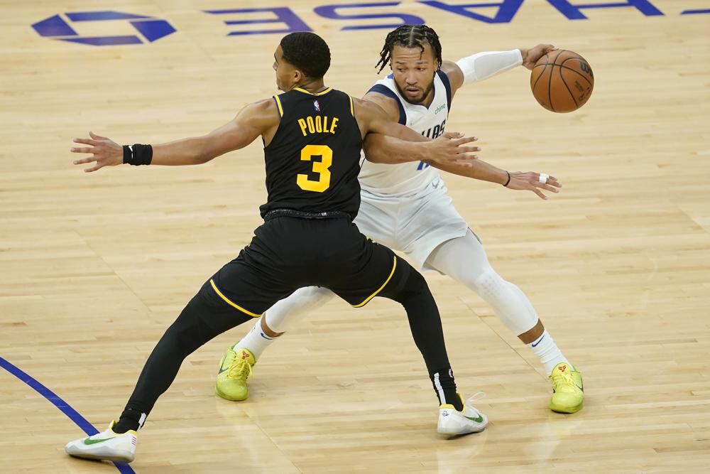 Dallas Mavericks guard Jalen Brunson, right, is defended by Golden State Warriors guard Jordan Poole (3) during the first half of Game 1 of the NBA basketball playoffs Western Conference finals in San Francisco, Wednesday, May 18, 2022.