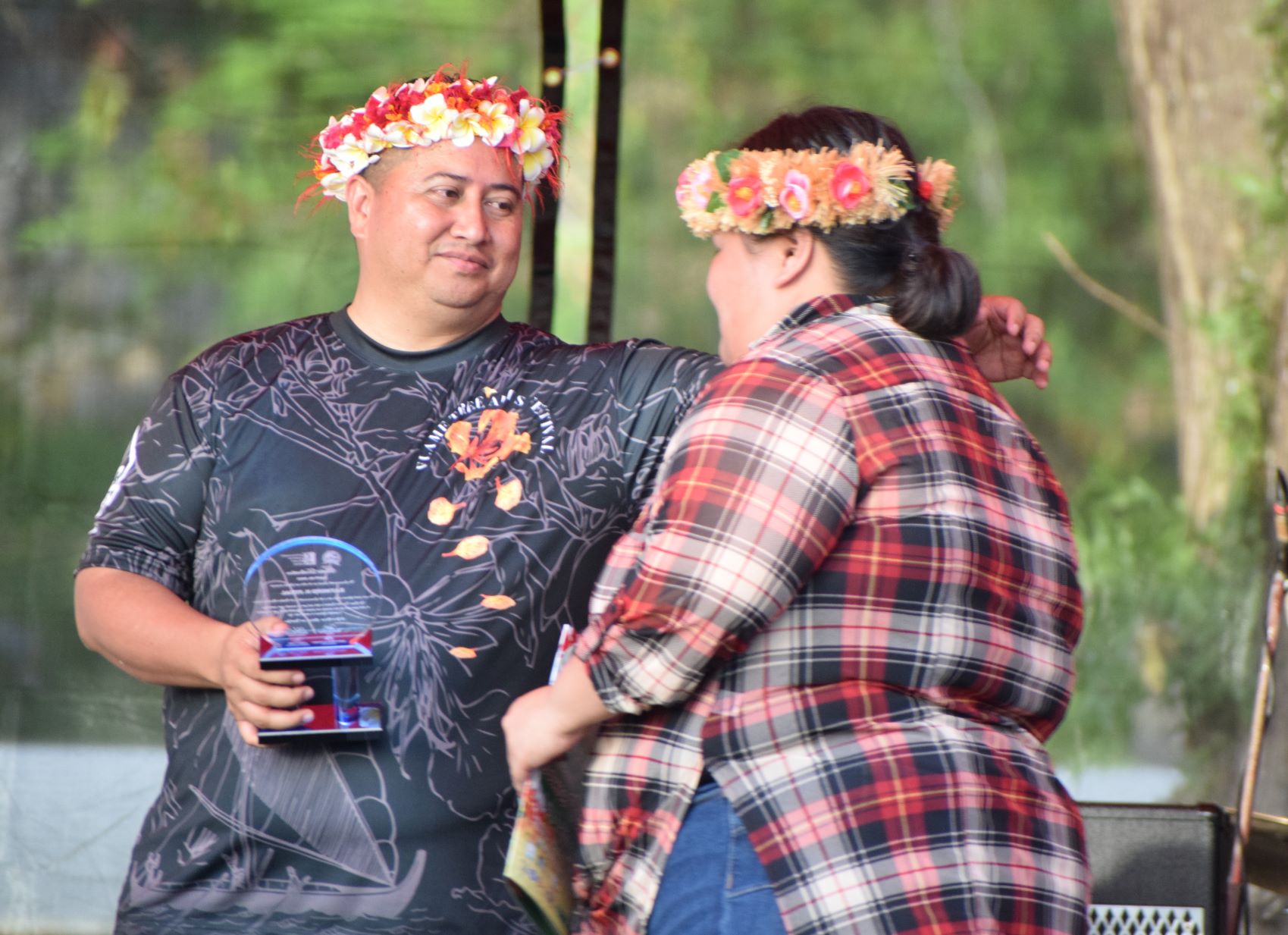 Republican Gov. Ralph DLG Torres congratulates a family member of one of the local artists who were honored during the opening day of  the Flame Tree Arts Festival at  Sugar King Park in Garapan on Saturday, April 29, 2022. 