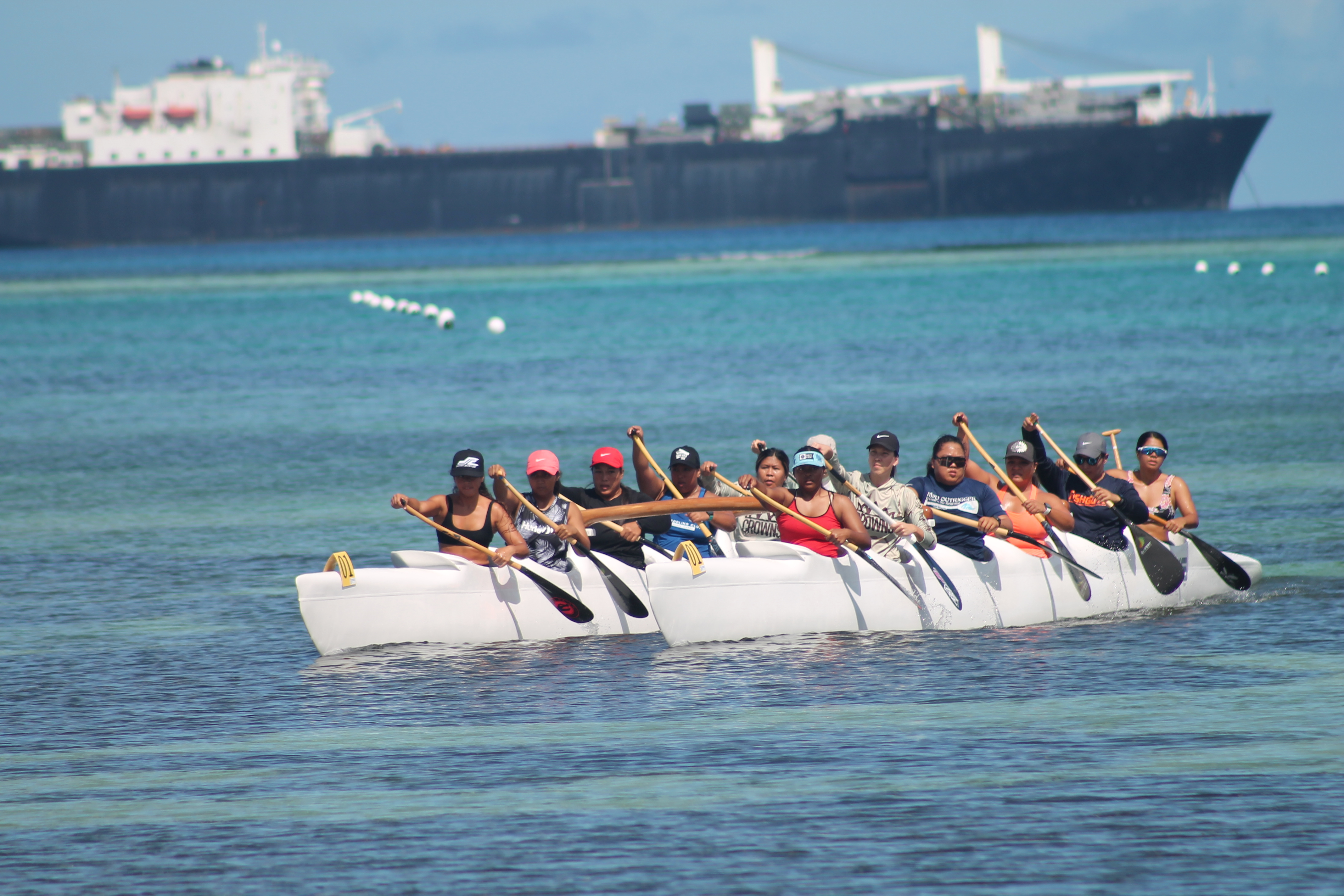 Prospective members of the CNMI women's team make their way to  the shore after testing the course in a V12 format during a dry run Saturday for the Pacific Mini Games 2022 at the 13 Fishermen Memorial beach.