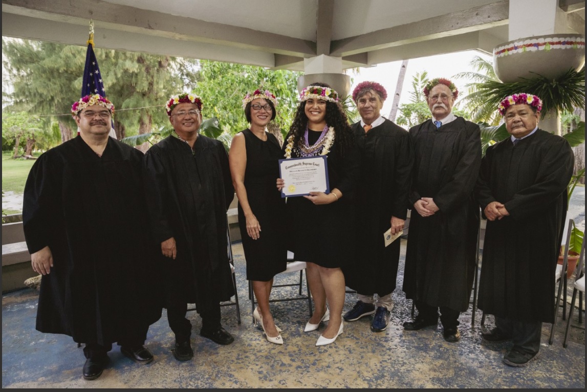 Attorney  Rellani Ogumoro, center, poses for a photo with Judge Joseph N. Camacho, Presiding Judge Roberto C. Naraja, Judge Teresa Kim-Tenorio, Judge Wesley Bogdan, Judge Kenneth L. Govendo, and Chief Justice Alexandro C. Castro.