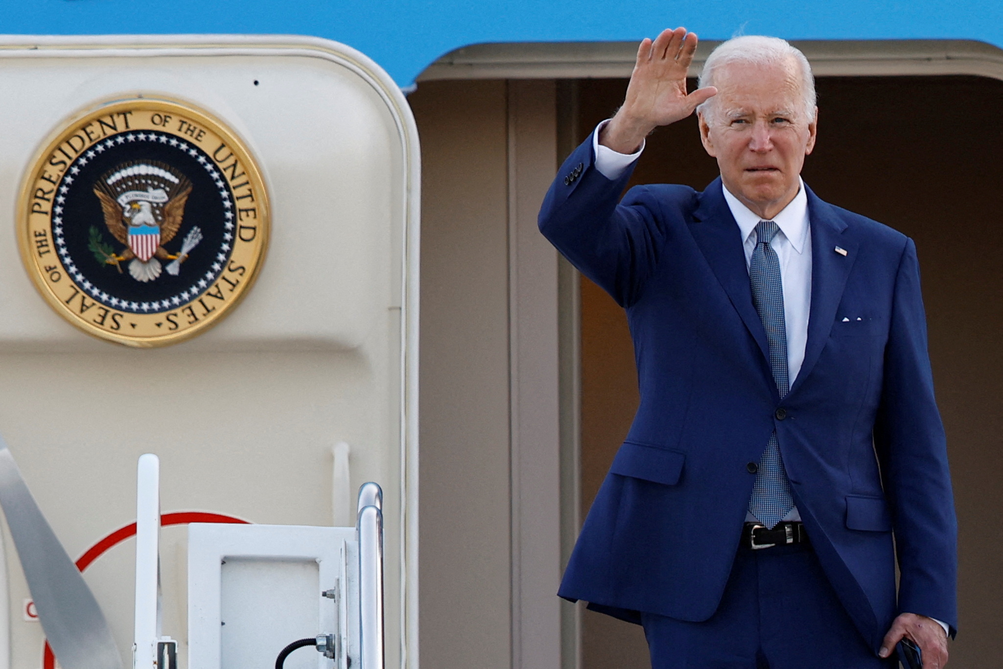 President Joe Biden gestures as he boards Air Force One to depart from Yokota Air Base in Fussa, on the outskirts of Tokyo, Japan, May 24, 2022.