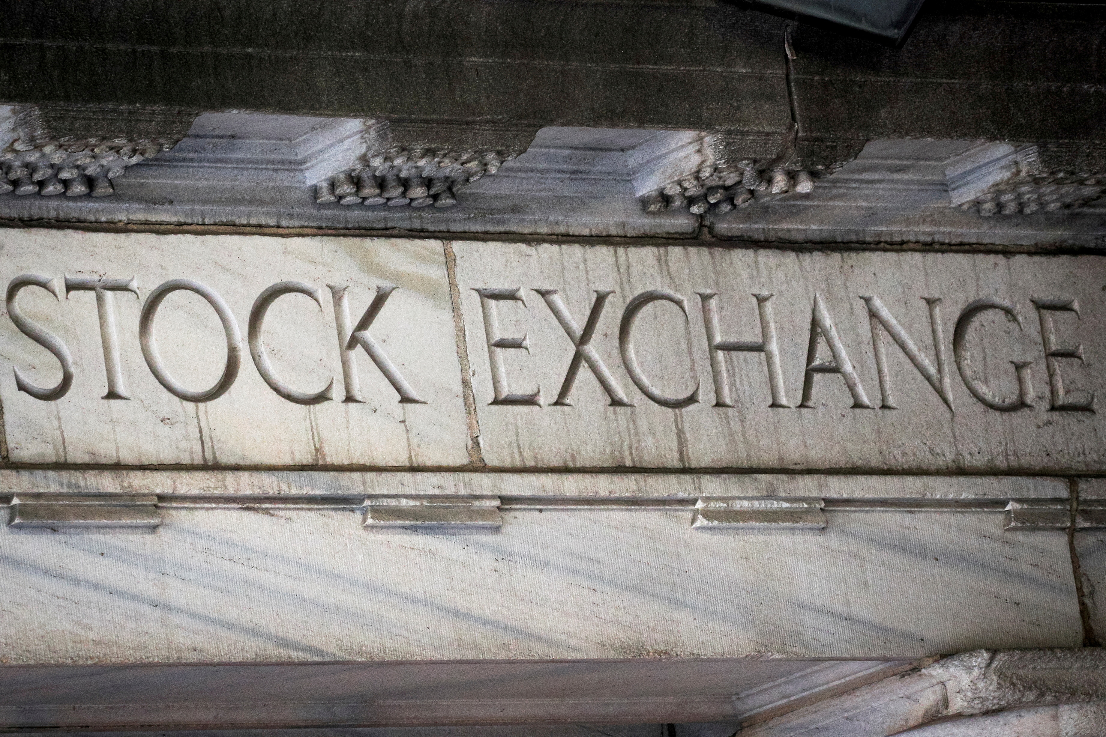 "Stock Exchange" is seen over an entrance to the New York Stock Exchange on Wall St. in New York City, March 29, 2021.