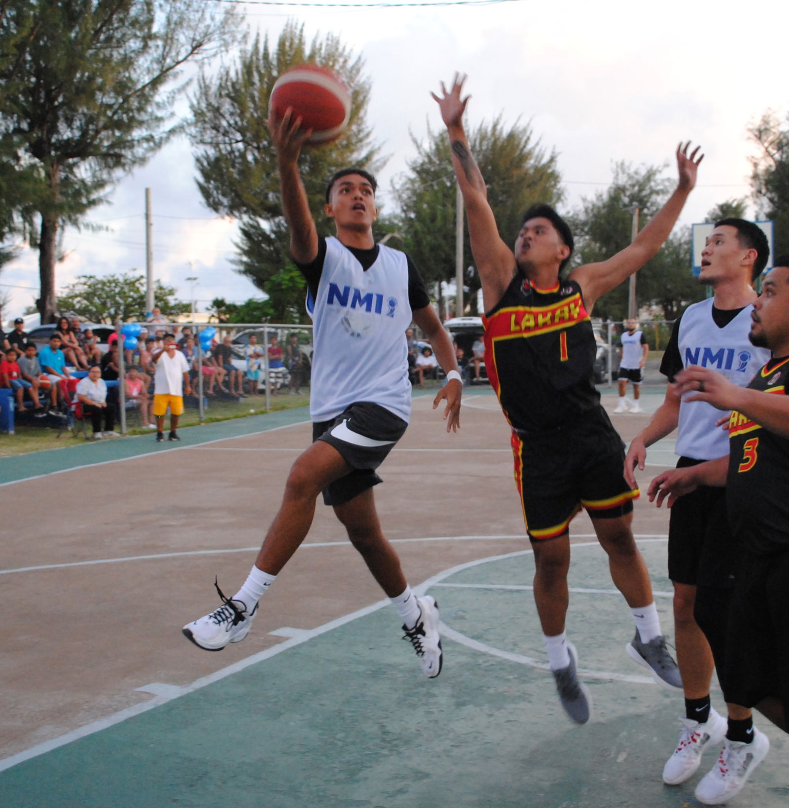 Marianas' Dela Cruz extends for the finish against Lakay's Santos during game 2 of the Saipan Centennial Lions Club Basketball League championship series at the Civic Center basketball court.