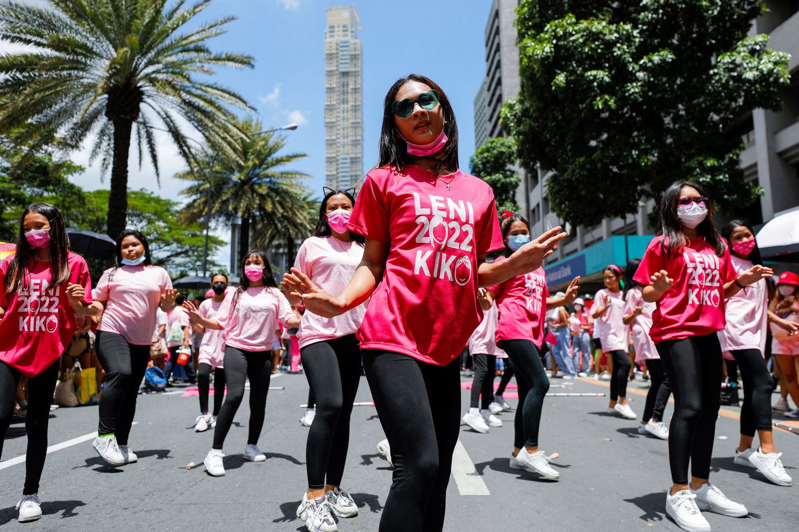 Supporters of Philippine Vice President and presidential candidate Leni Robredo dance while taking part in a campaign rally ahead of the 2022 national election in Makati, Metro Manila, May 7, 2022.