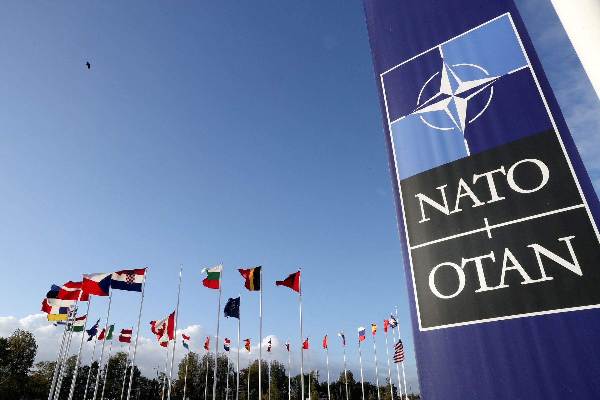 Flags wave outside the Alliance headquarters ahead of a NATO Defense Ministers meeting, in Brussels, Belgium, Oct. 21, 2021. 