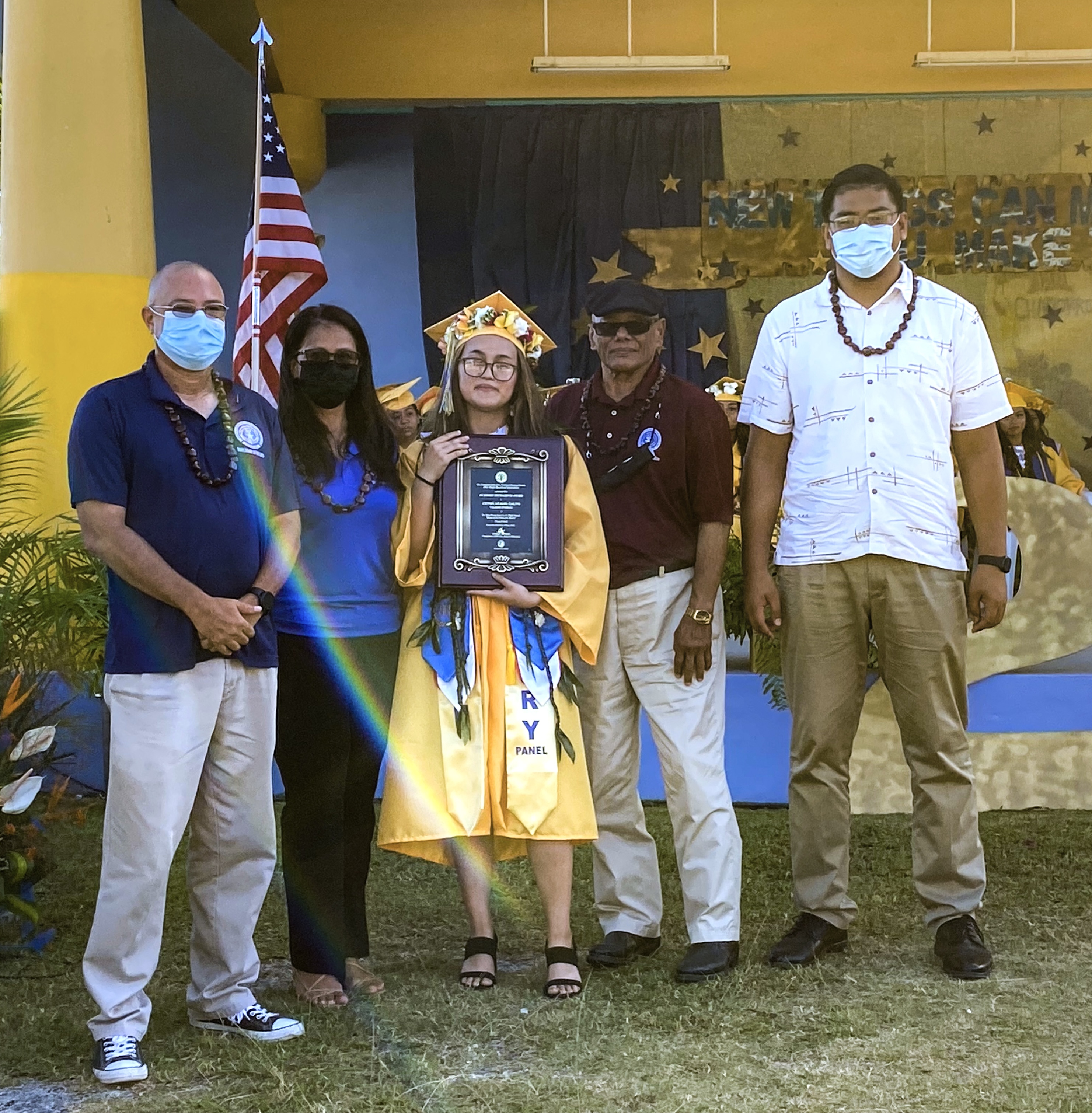 Doctor Rita Hocog Inos High School valedictorian Cevon Atalig Calvo is presented with the Board of Education Award by BOE Chairman Gregory Pat Borja, Vice Chairman Antonio L. Borja, Secretary-Treasurer Maisie B. Tenorio and Rota Board Member Herman T. Atalig.