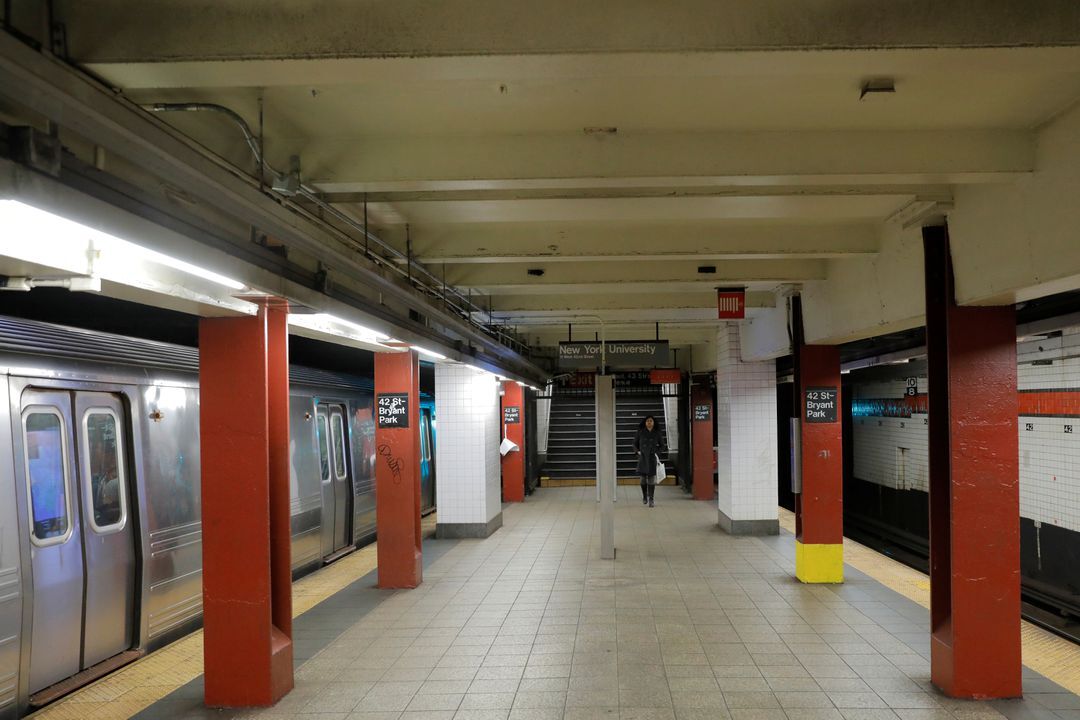 A commuter walks through the 42nd Street Bryant Park subway station during what is typically rush hour, but is largely empty due to the coronavirus disease, forcing large numbers of people to stay home in Manhattan, New York City, March 18, 2020.
