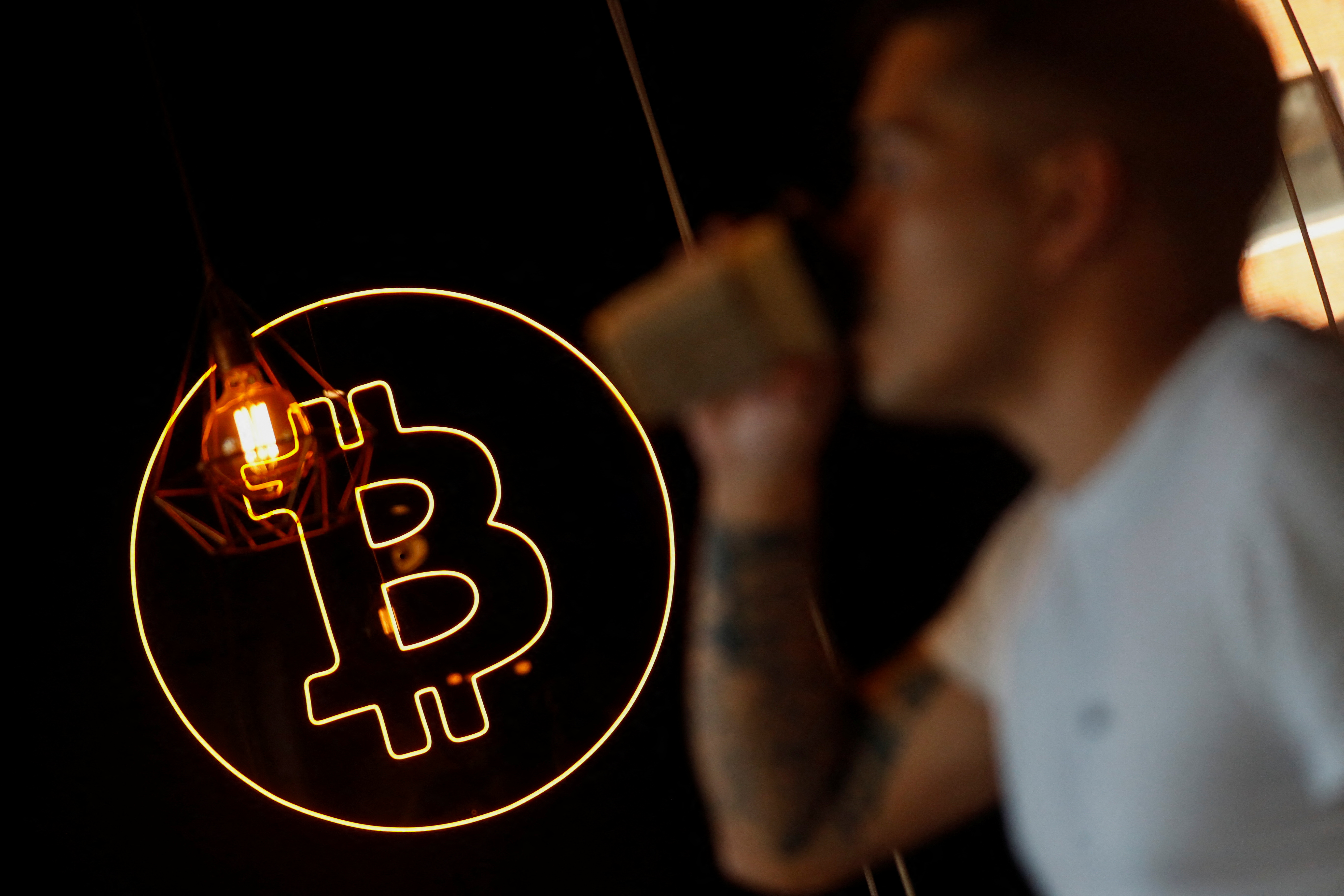 A neon logo of cryptocurrency Bitcoin is seen at the Crypstation cafe, in downtown Buenos Aires, Argentina on May 5, 2022.