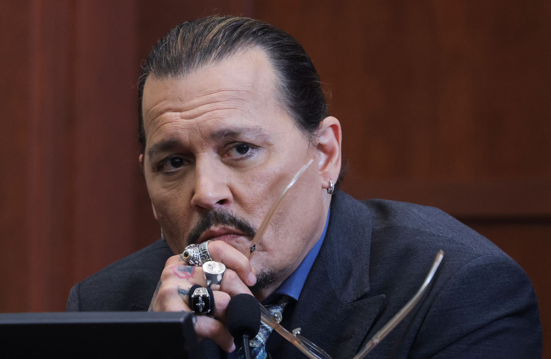 Actor Johnny Depp listens to a question as he testifies in the courtroom during his defamation trial against his ex-wife Amber Heard, at the Fairfax County Circuit Courthouse in Fairfax, Virginia, May 25, 2022.