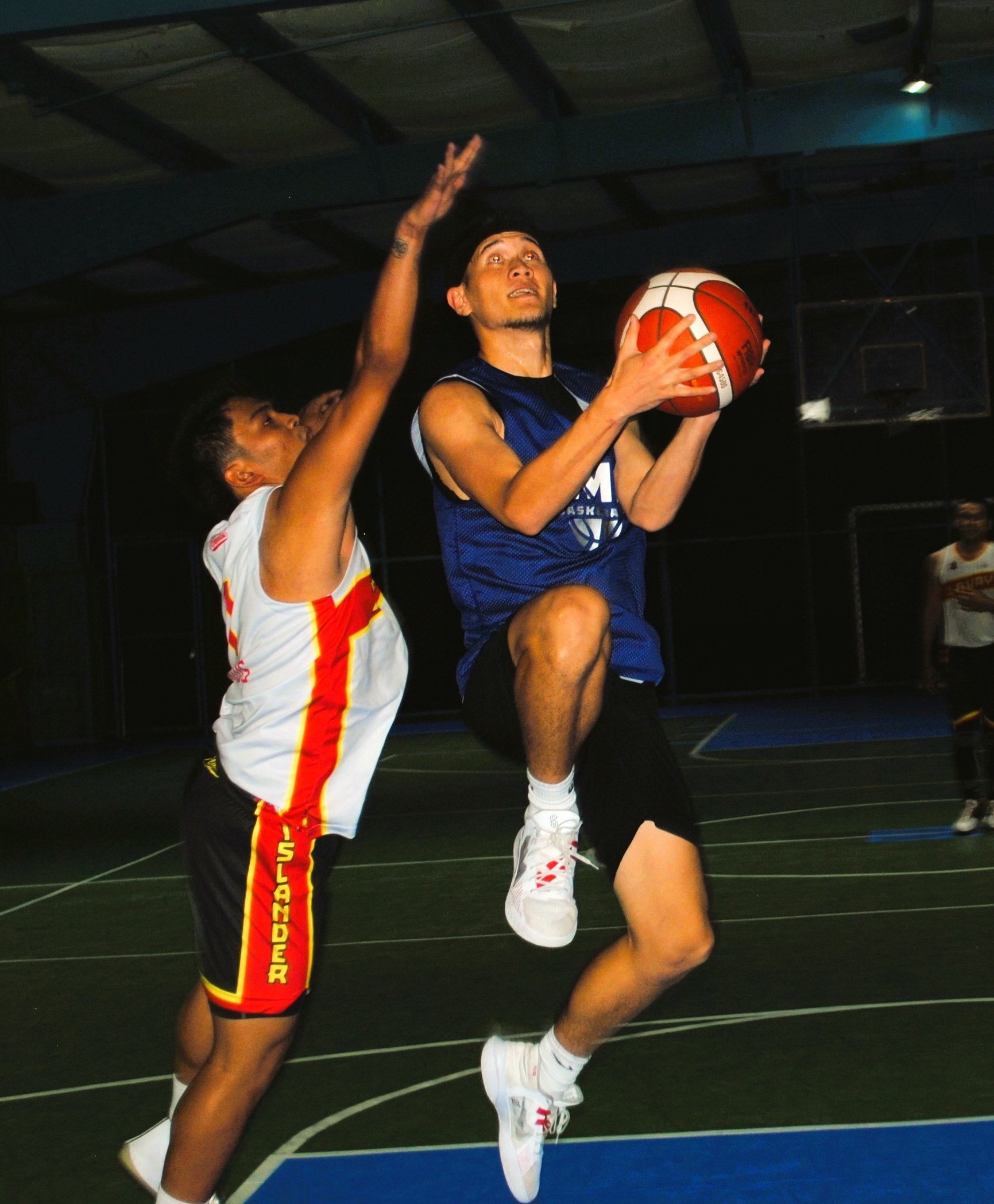Marianas' Deleon Guerrero rises up for the reverse layup against Lakay's Jandoc during the open division championship game of the Saipan Centennial Lions Club Basketball League Friday at the TSL Sports Complex.