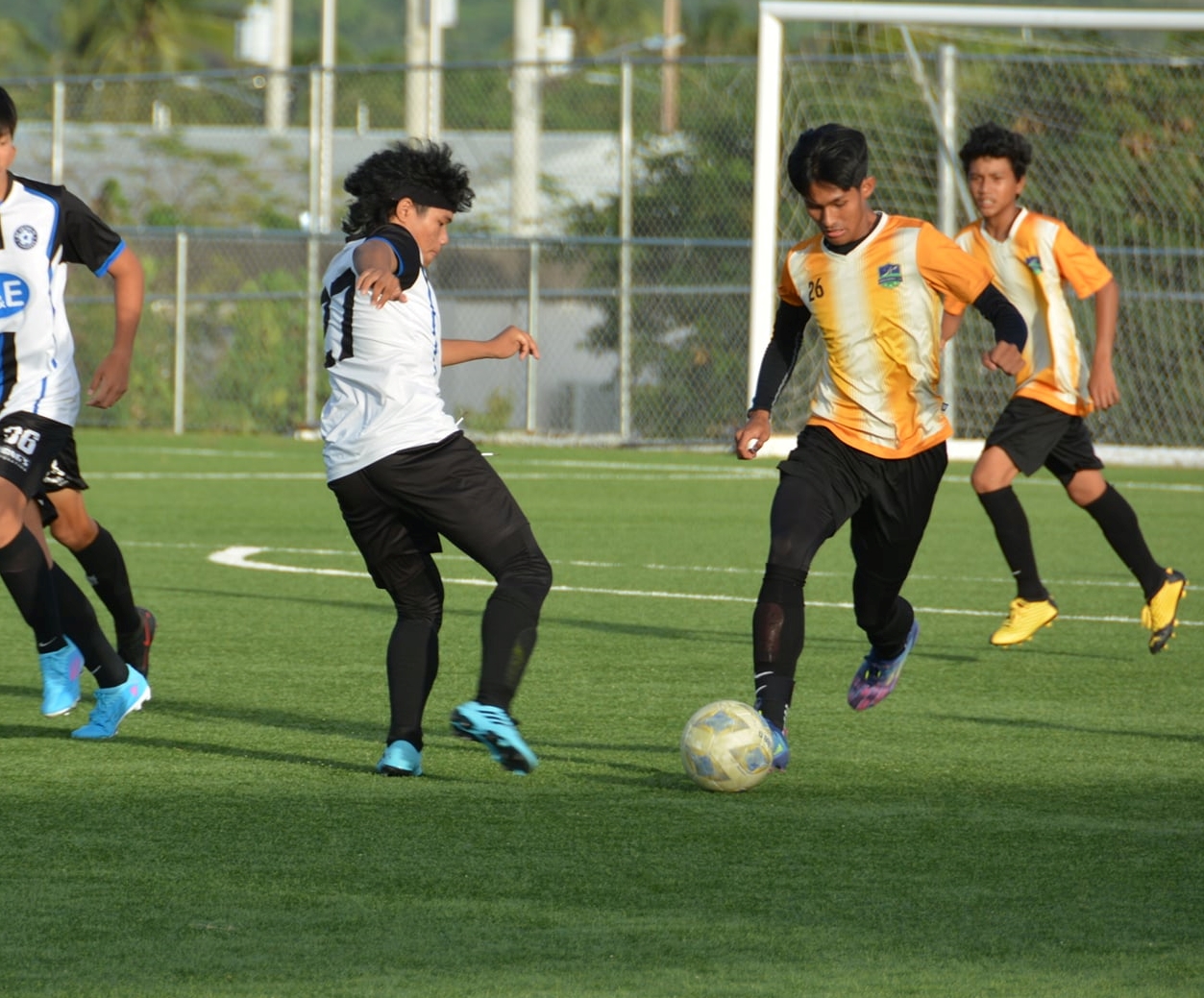 Kanoa’s Markus Toves pushes forward in transition during a U16 boys division game of the TakeCare Youth Soccer League at the NMI Soccer Training Center.