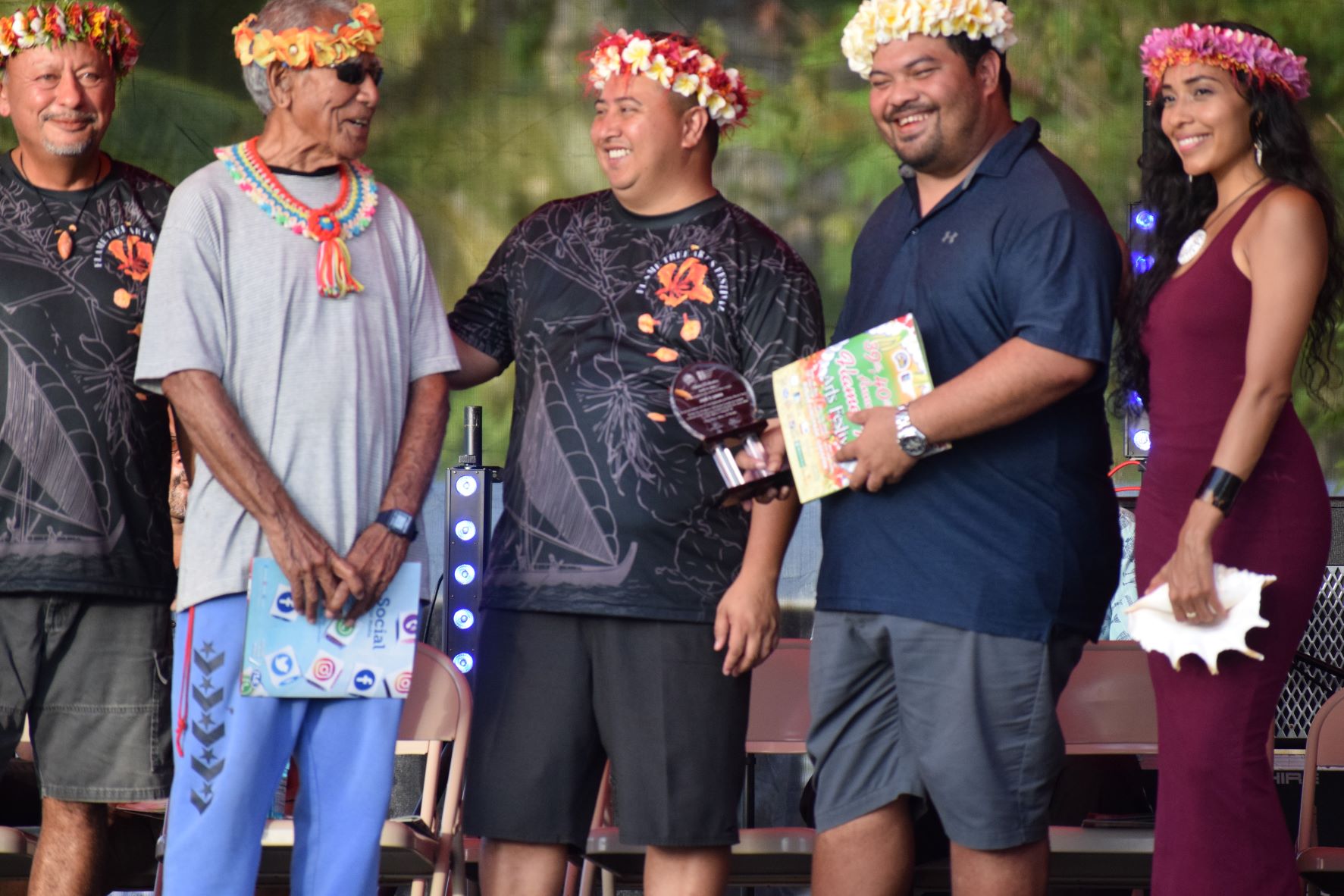 Gov. Ralph DLG Torres, center, smiles with indigenous culture advocate Lino Olopai, 2nd left, after a family member of the late artist Jose Limes received his posthumous award. Also in the photo are Department of Community and Cultural Affairs Secretary Joseph P. Deleon Guerrero and mistress of ceremonies Eva Cruz.