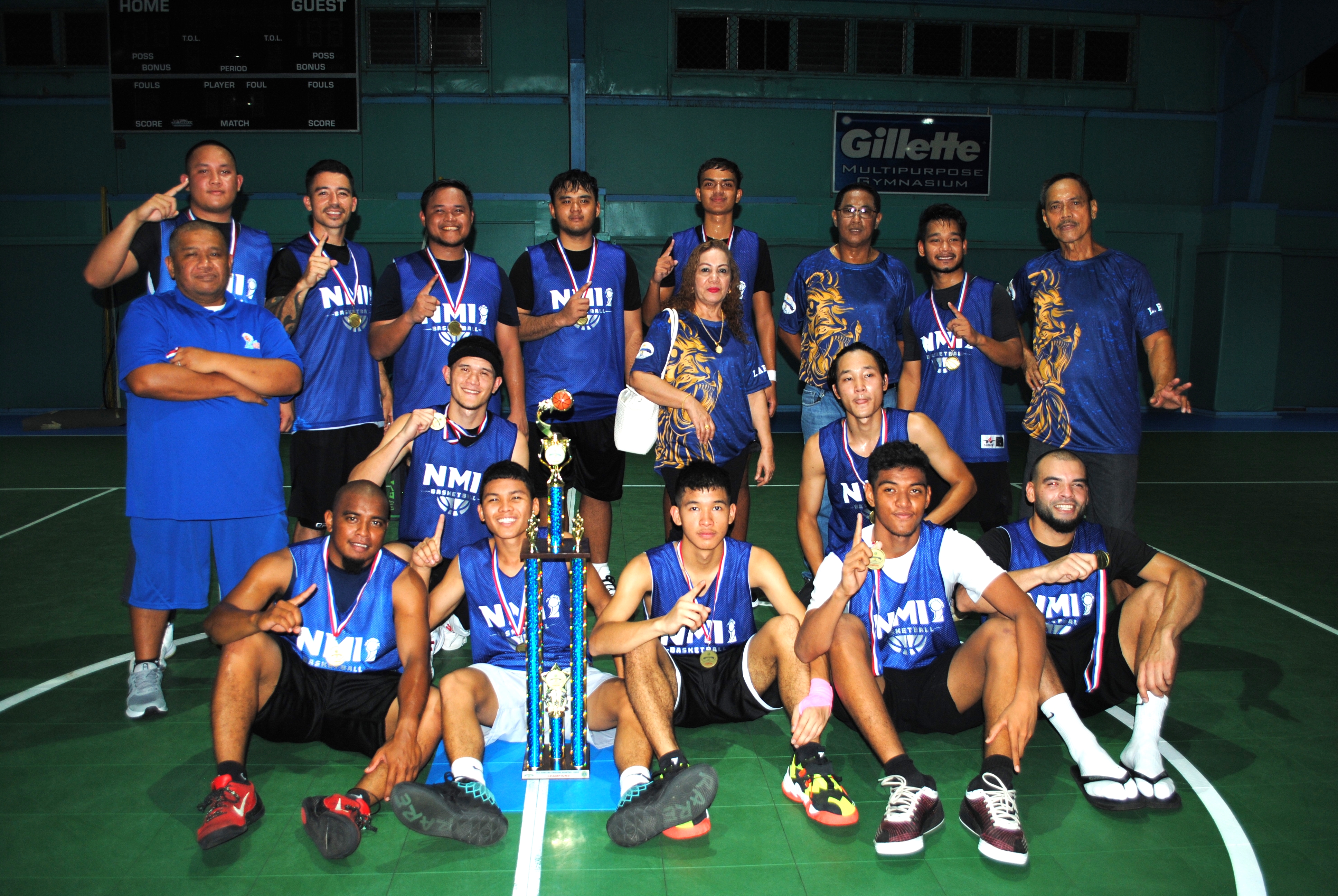 Team Marianas players pose with the open division championship trophy of the Saipan Centennial Lions Club Basketball League Friday at the TSL Sports Complex