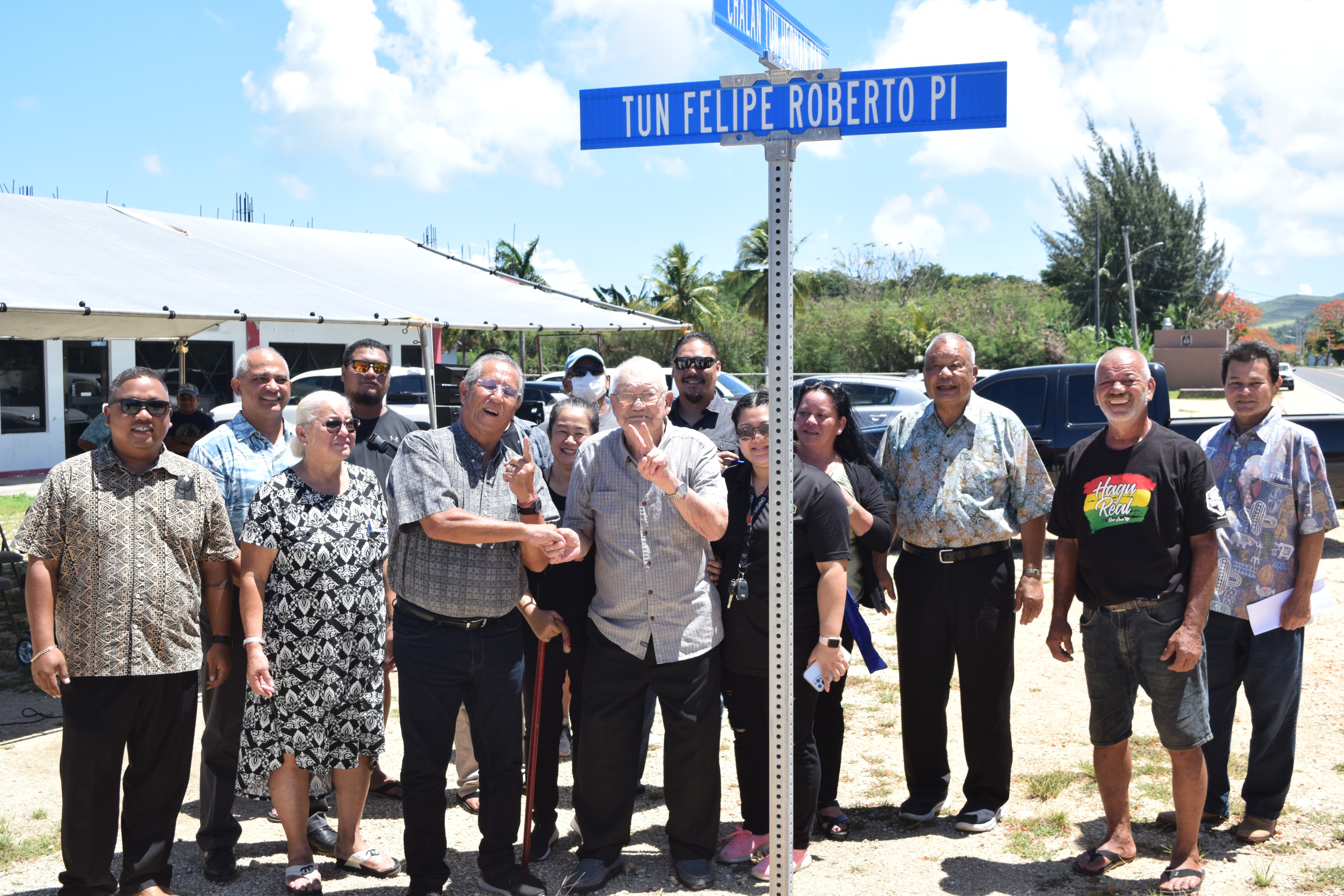 Felipe Ada Roberto, center, flashes a victory sign as he poses for a photo with his family members, Saipan Mayor David M. Apatang, Rep. Joseph Leepan Guerrero, House Minority Leader Angel Demapan and Rep. Joseph Flores at the unveiling of the Tun Felipe Roberto Place street name in Dandan.