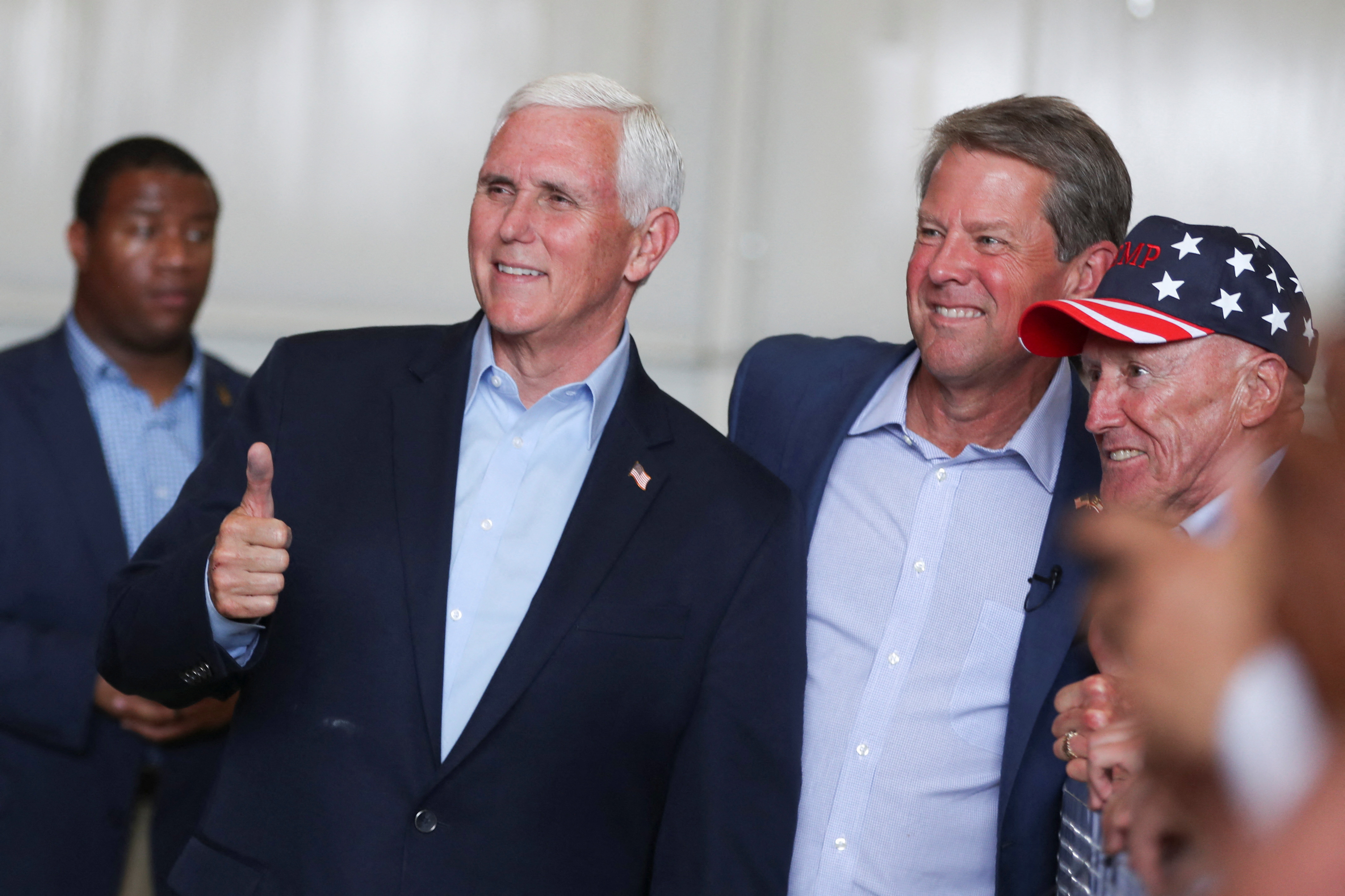 Former Vice President Mike Pence and Georgia Gov. Brian Kemp pose for a picture as they attend a rally ahead of the state's Republican primary in Kennesaw, Georgia, May 23, 2022.