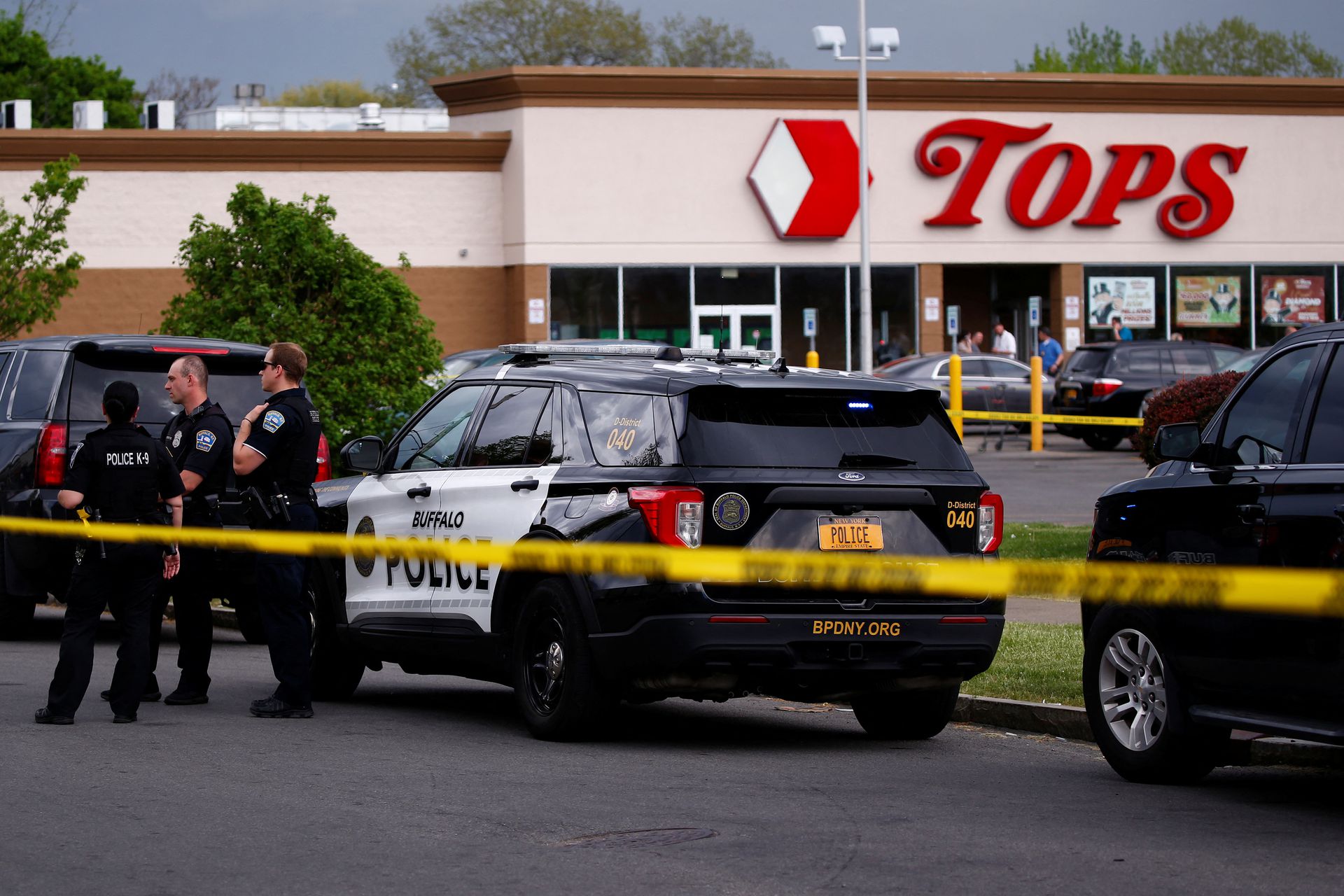 Police officers secure the scene after a shooting at TOPS supermarket in Buffalo, New York, May 14, 2022.