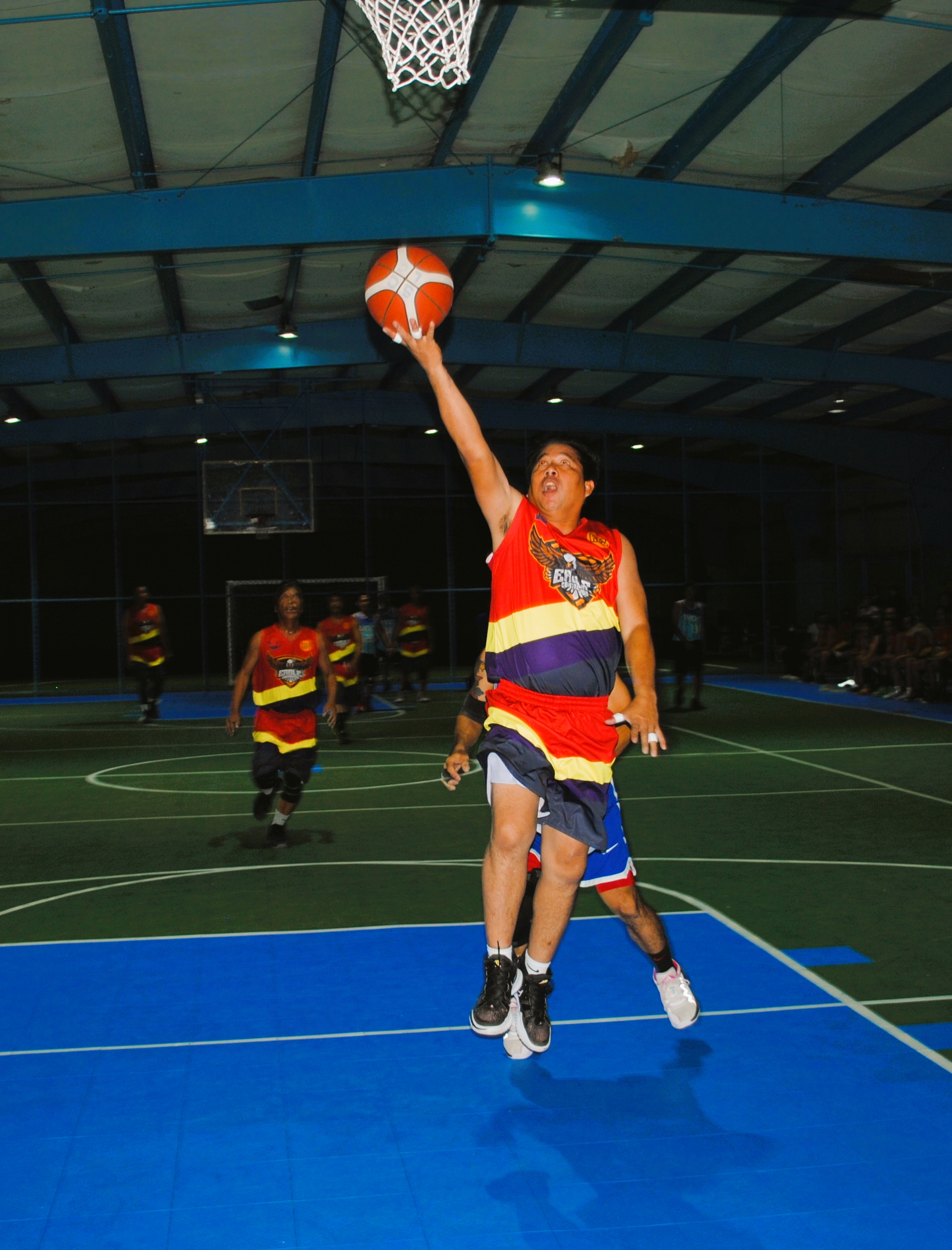 Eagle Construction's Umali extends for the uncontested shot during a masters division game of the Saipan Centennial Lions Club Basketball League at the TSL Sports Complex.