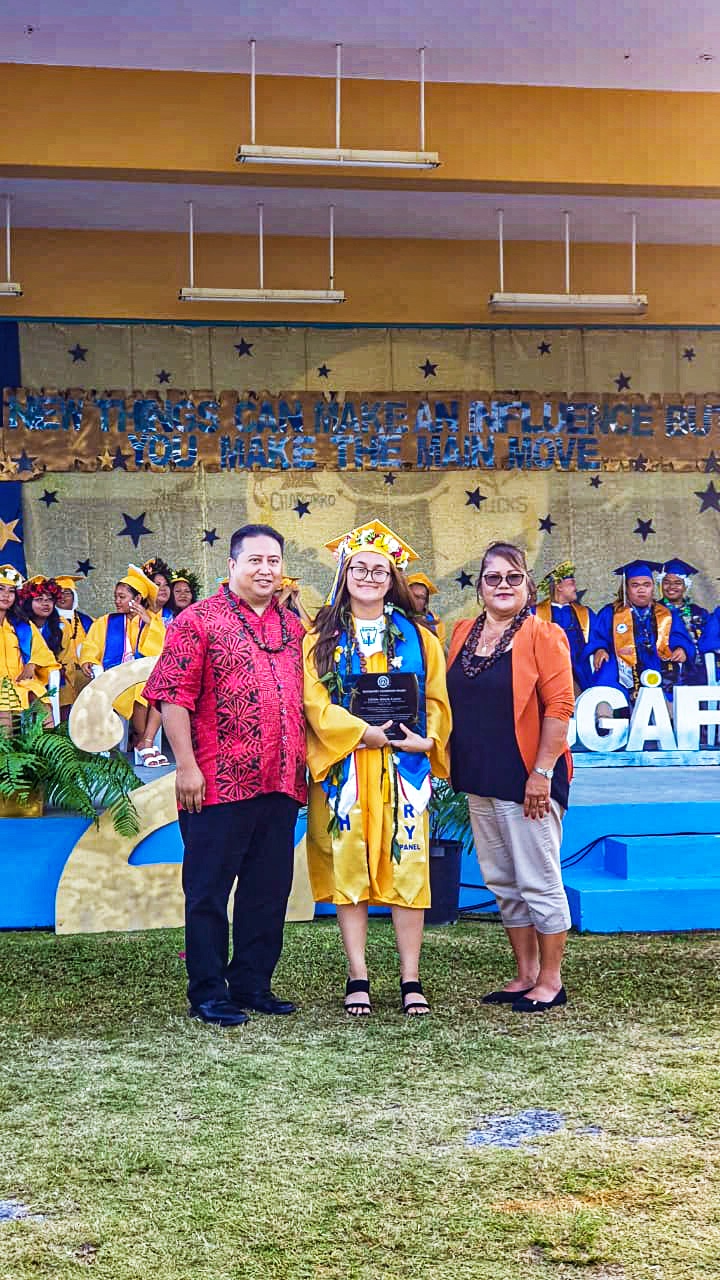 High school valedictorian Cevon Atalig Calvo receives the Governor’s Award and Outstanding Female Graduate Award from Gov. Ralph DLG Torres and  Joaquina King of the Rota Women’s Affairs Office.