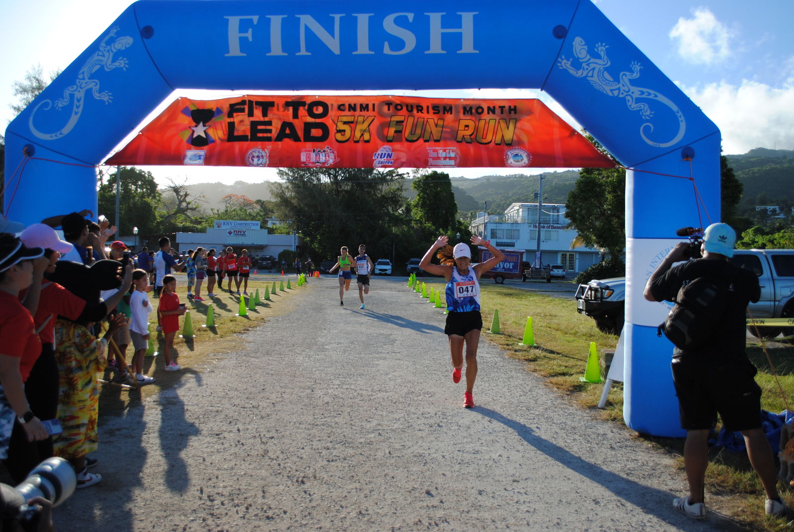 Akiko Miller celebrates as she reaches the finish line of the Fit to Lead 5K Tourism Month Fun Run at the Garapan Fishing Base.