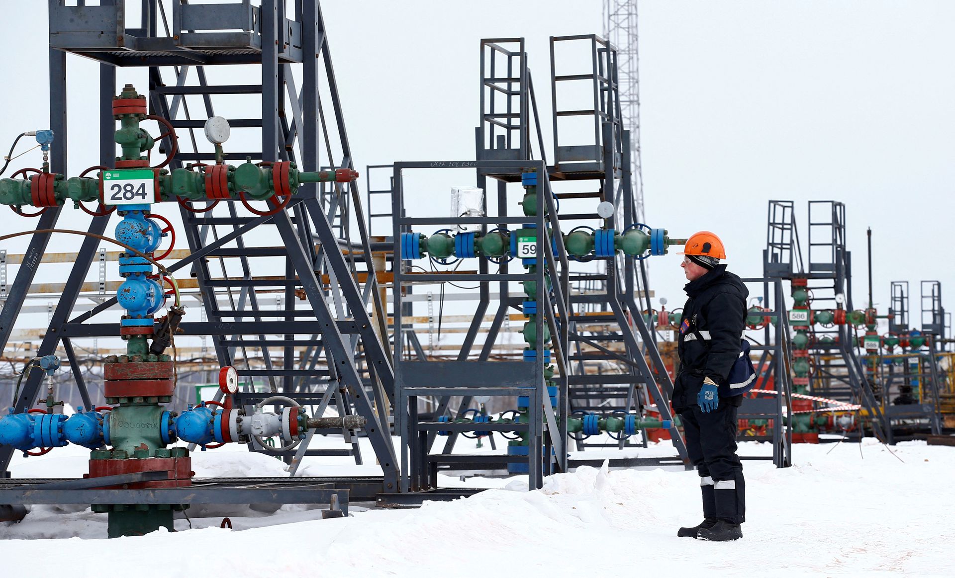 An employee inspects a well head in the Yarakta Oil Field, owned by Irkutsk Oil Company, in Irkutsk Region, Russia on March 10, 2019.