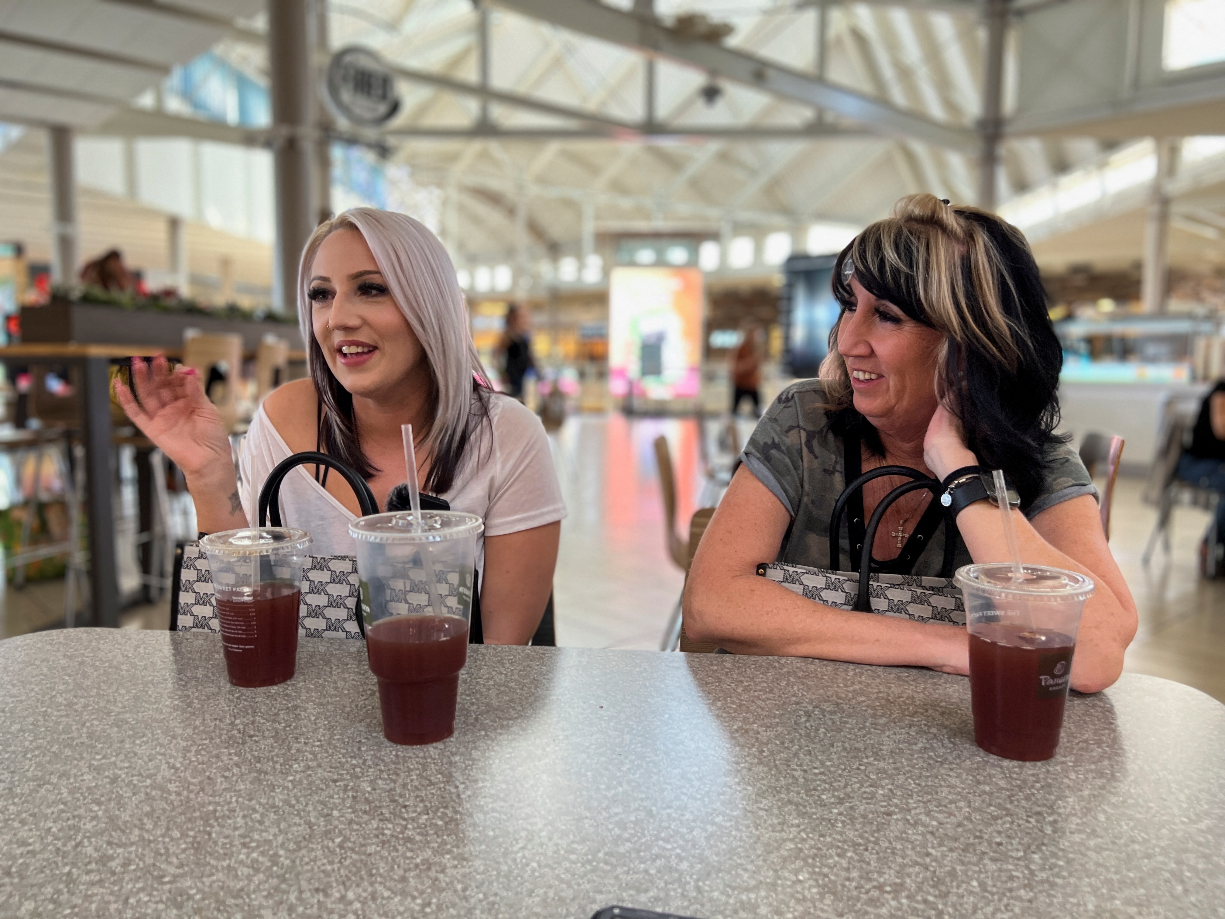 Sherica Bailey speaks at a food court table while her mother looks, after sharing with Reuters her personal story about abortion rights and why she is against abortion, Glendale, Arizona on May 5, 2022.
