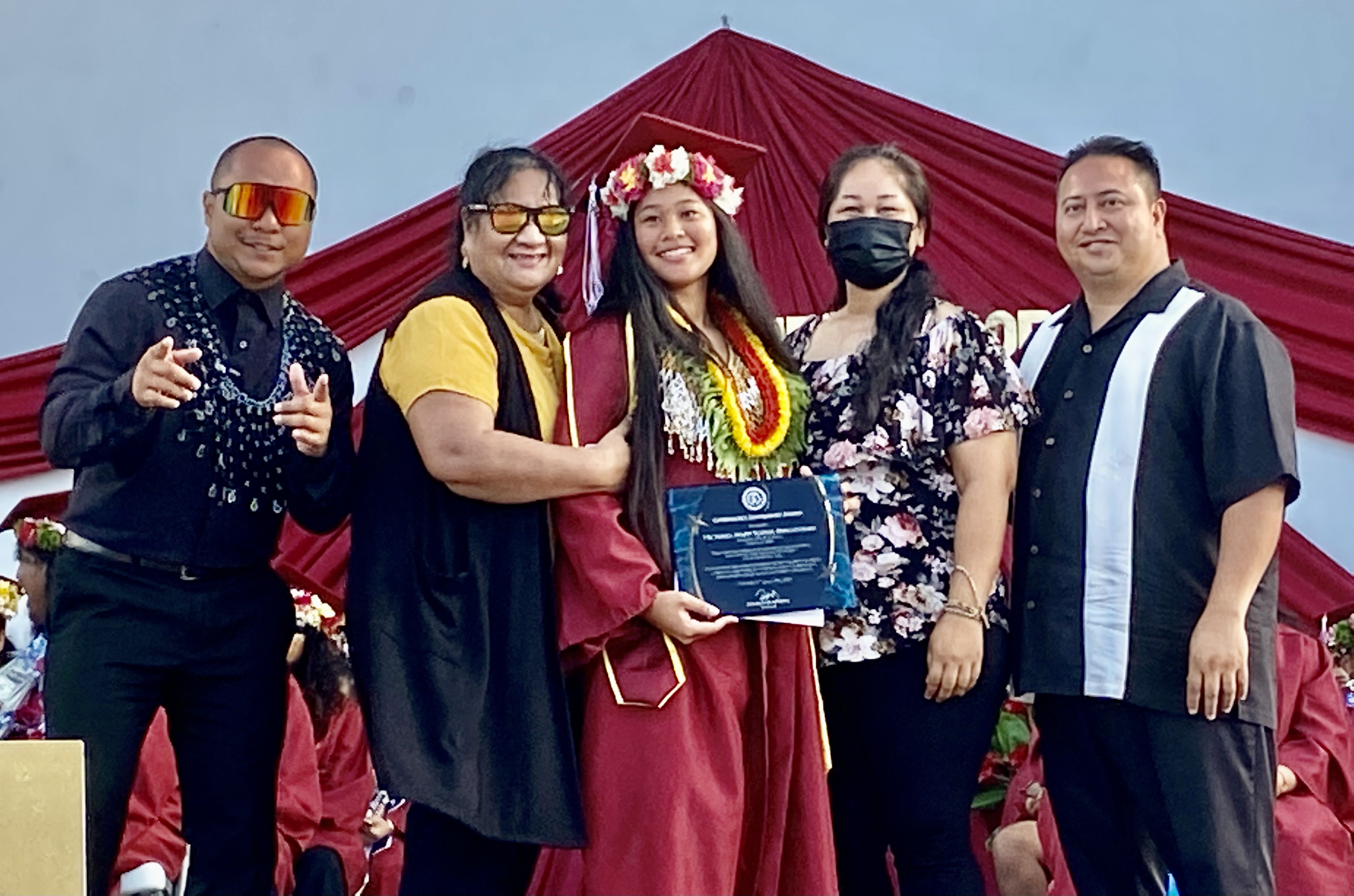Victoria Mary Igitol Pangelinan receives the Governor’s Award from Gov. Ralph DLG Torres. Also in photo are her parents and KHS Principal Ben Jones.