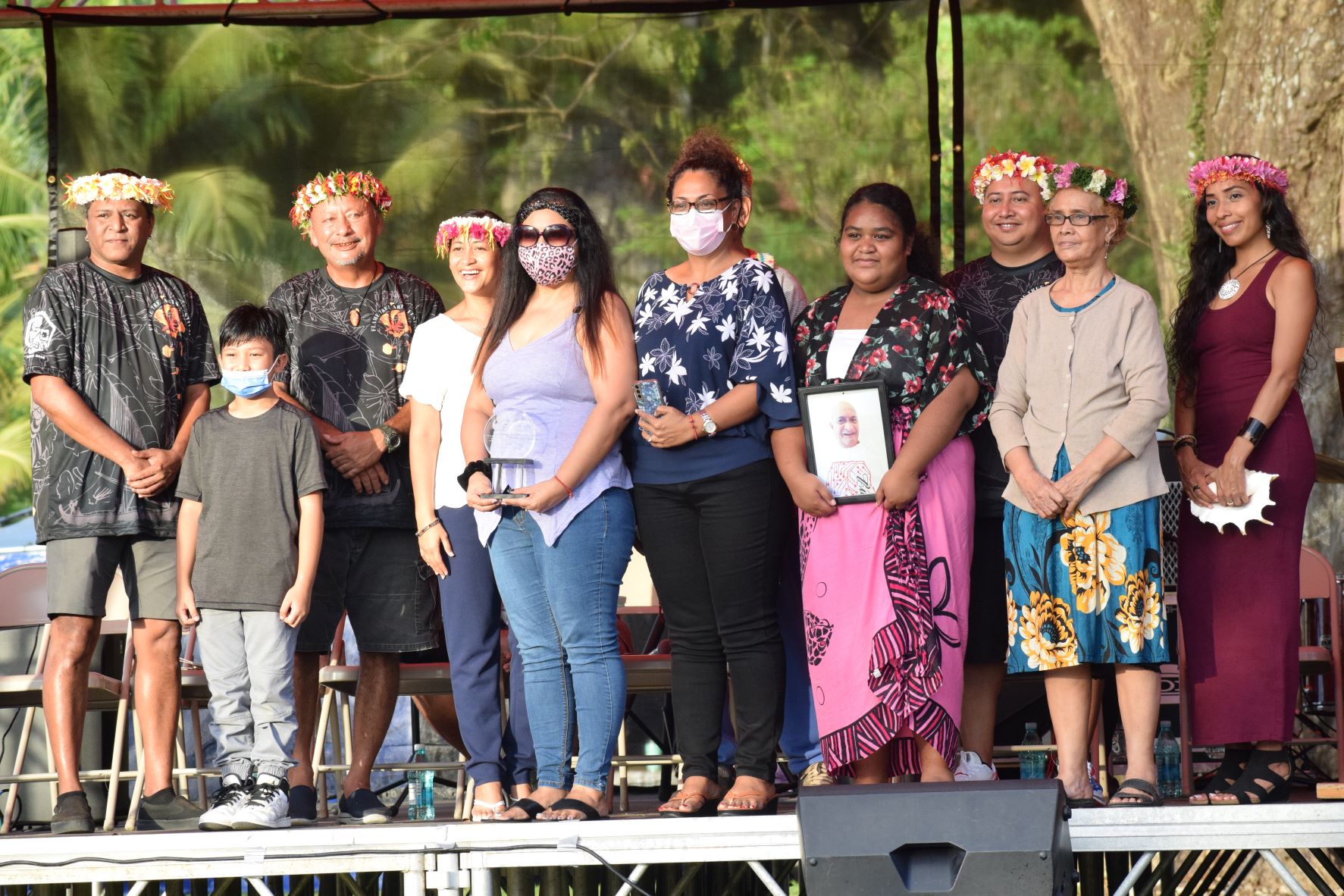 Gov. Ralph DLG Torres, third right, first lady Diann Torres, fourth left, Department of Community and Cultural Affairs Secretary Joseph P. Deleon Guerrero, third left, Arts Council Executive Director Parker Yobei, left, and mistress of ceremonies Eva Cruz, right, join the family of the late local artist Faustina Tebuteb.