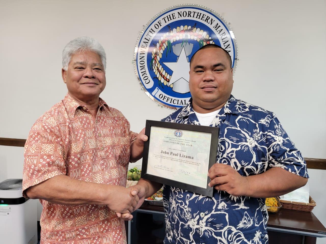 Lt. Gov. Arnold I. Palacios, left, presents  the 2022 Lt.  Governor’s Office  Employee  of the Year  award  to building maintenance specialist John Paul “JP” Lizama at the lt. governor’s office on Capital Hill, Tuesday, May 3, 2022.