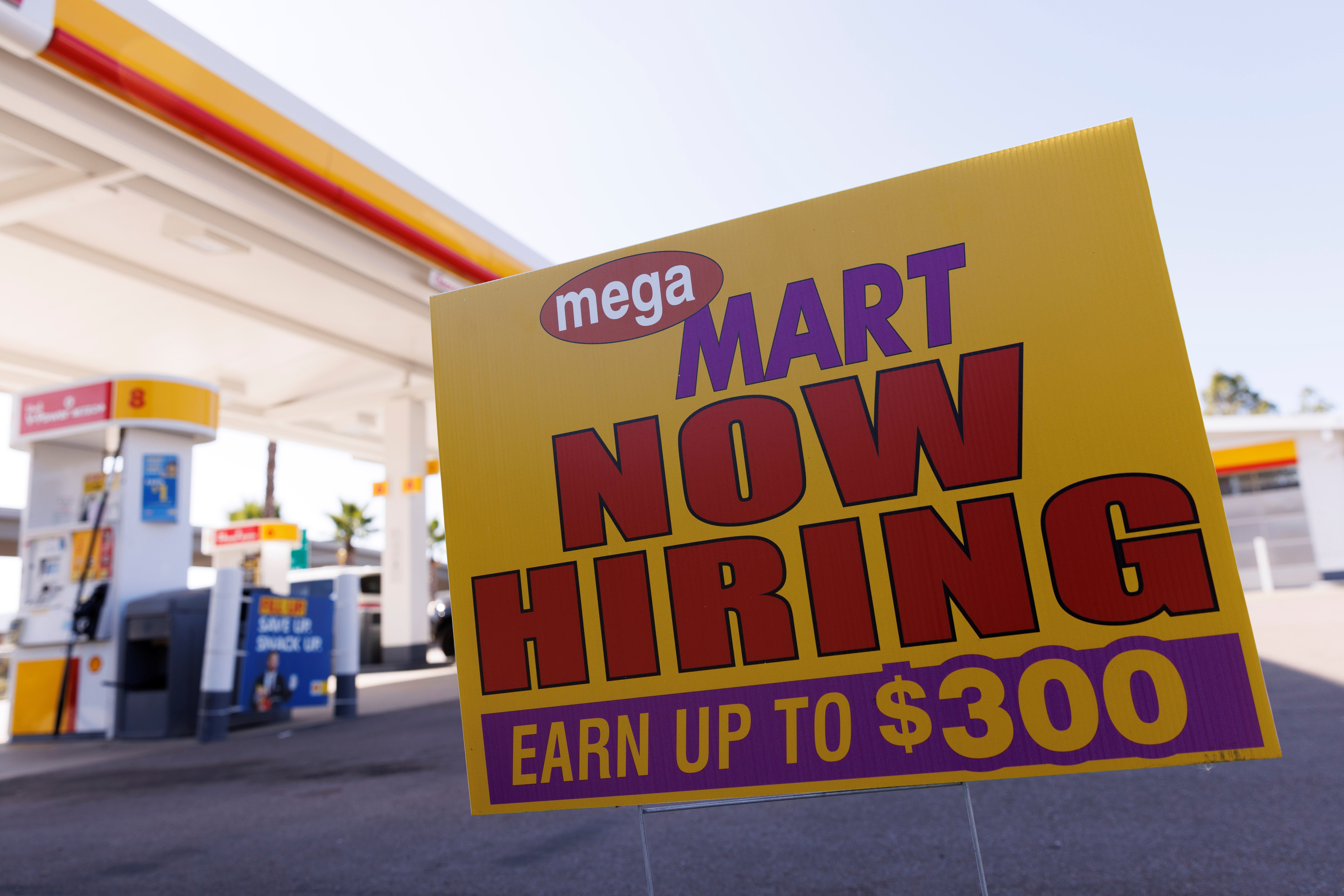 A job posting looking for workers is shown at a gas station in San Diego, California, Nov. 9, 2021.