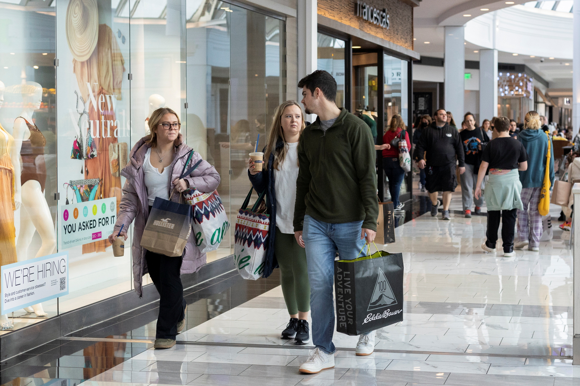 People carrying shopping bags walk inside the King of Prussia shopping mall, as shoppers show up early for the Black Friday sales, in King of Prussia, Pennsylvania on Nov. 26, 2021.
