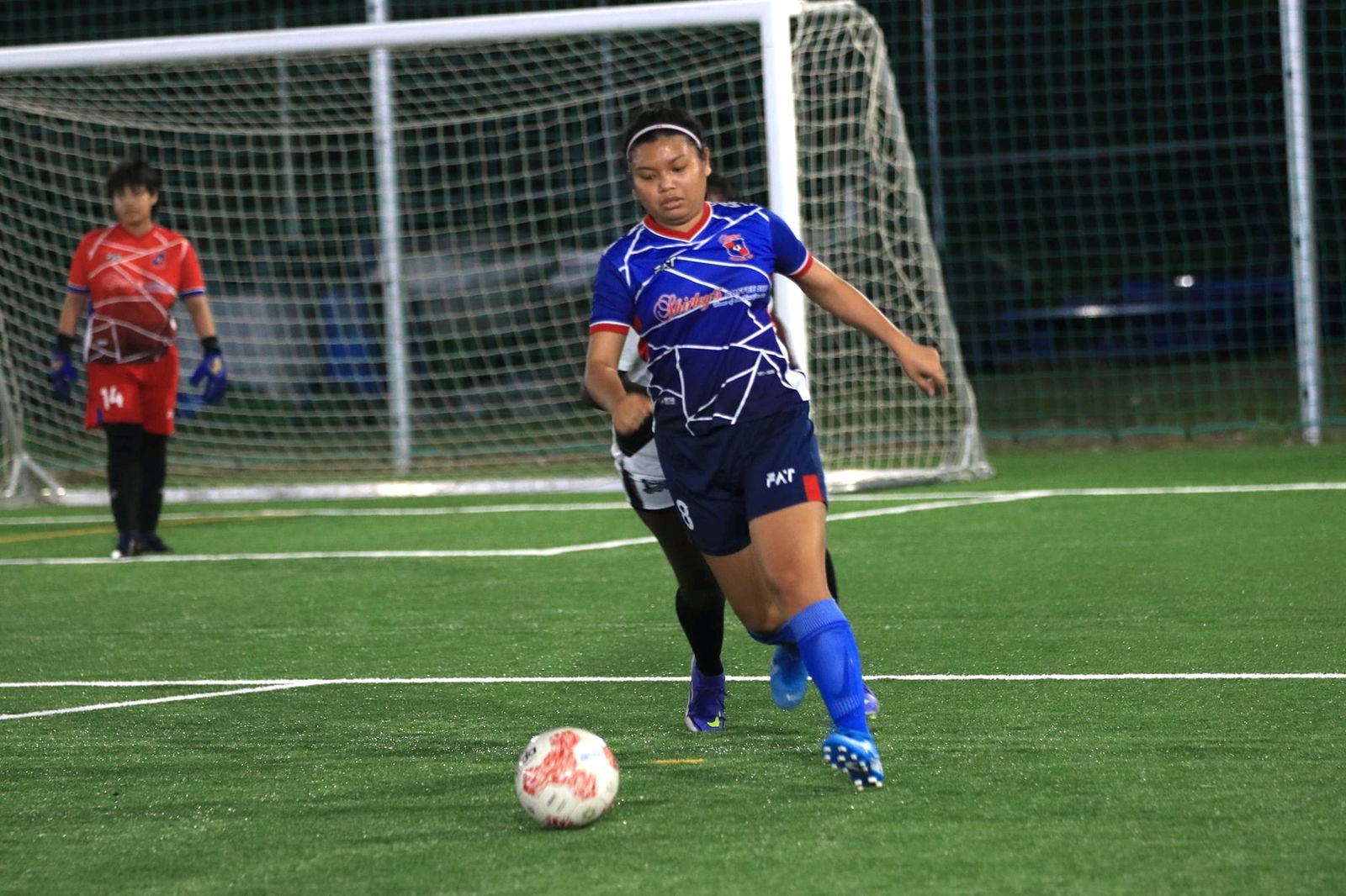 Shirley's Marrielle Gariguez sets up the play during an Intermediate Division, Group A game of the Dove Women’s League at the NMI Soccer Training Center.