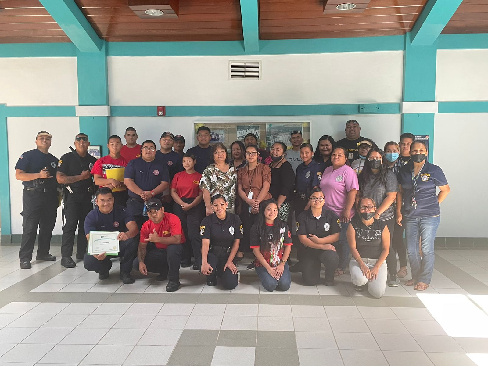 Participants pose with facilitators Fred Fatialofa, last row, far right, and Queayla Sablan, front row, third right, after completing the Applied Suicide Intervention Skills Training.