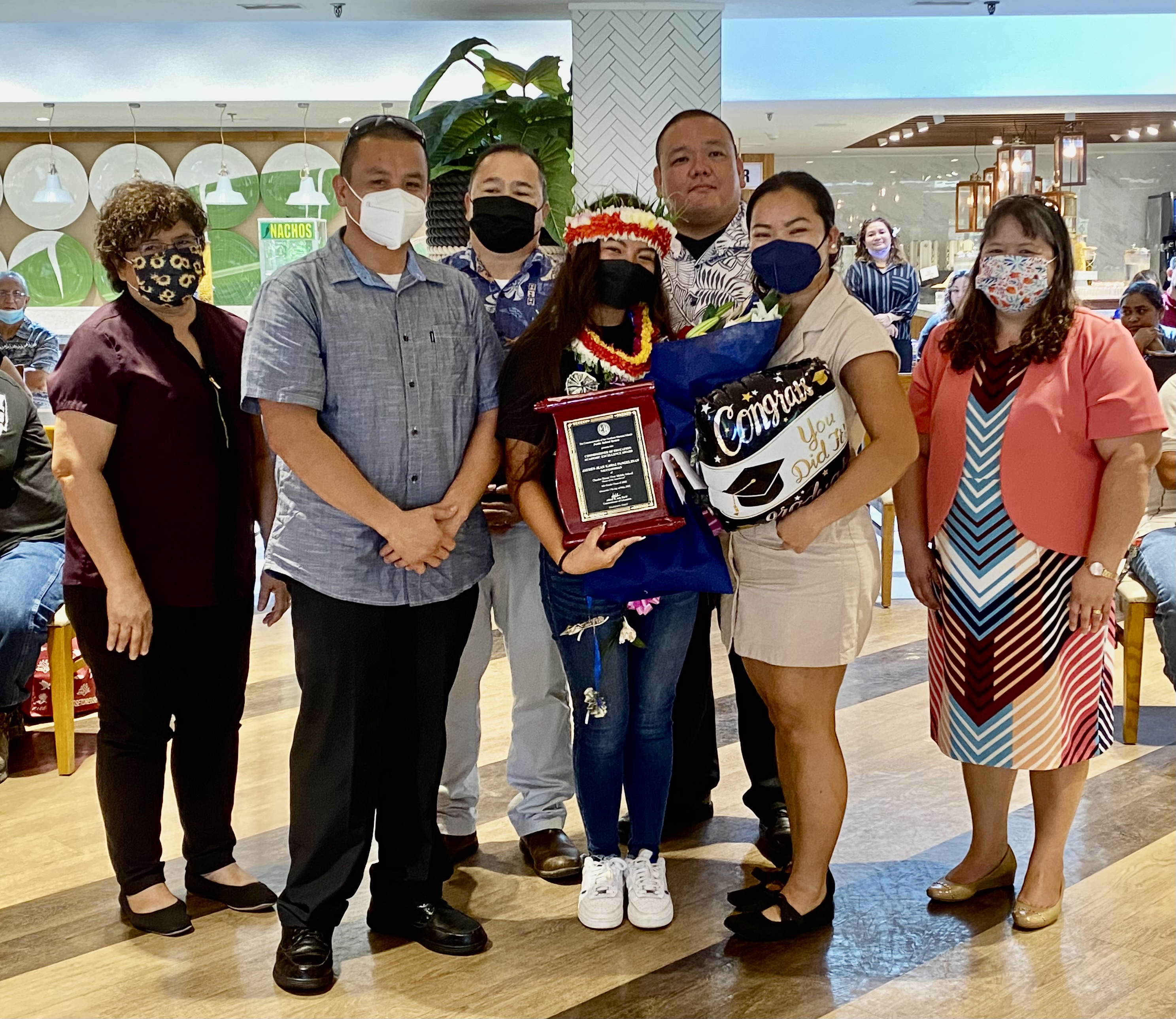 Chacha class salutatorian and Commissioner of Education awardee Jayden Jean Kawaii Pangelinan and his parents pose for a photo with Commissioner of Education Dr. Alfred B. Ada, Associate Commissioner for Administrative Services Eric Magofna, Senior Directors Jackie Quitugua and Dr. Rizalina Liwag.