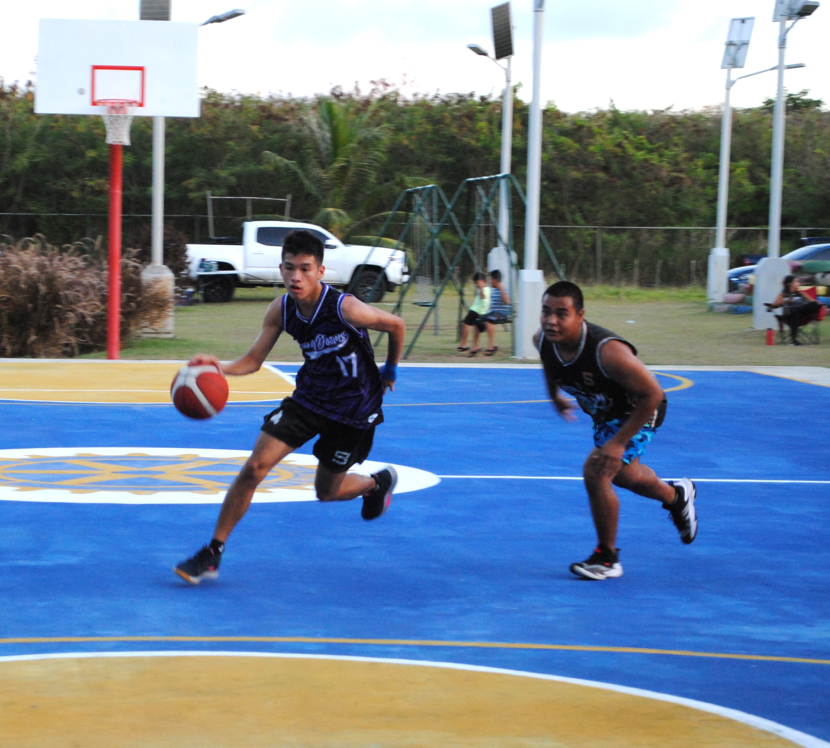 Young Doom's Leo Naraja dribbles past a defender.