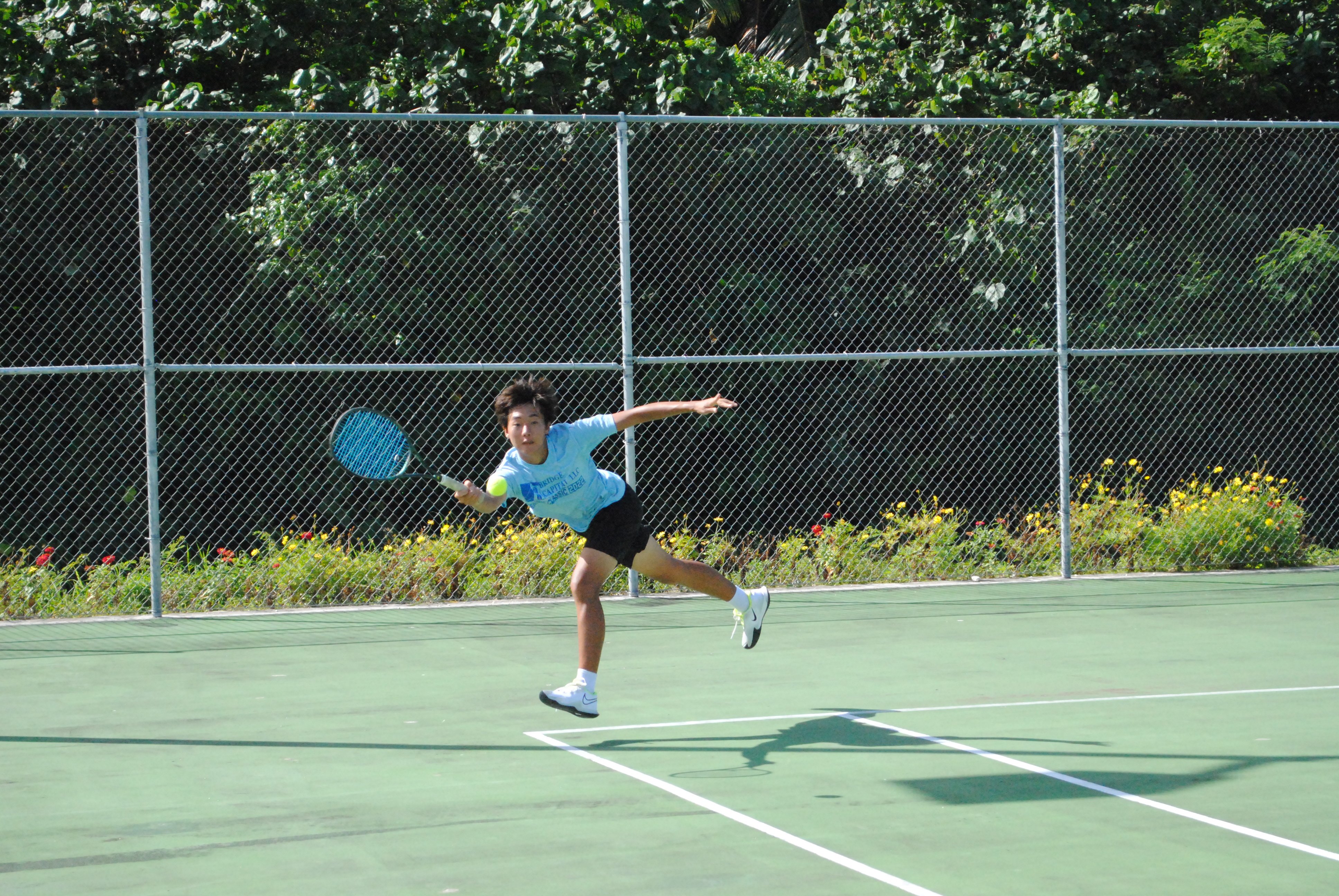 David Kwon reaches out for the save during a boys doubles-18 game of the 2022 TSL CNMI Junior Tennis Tournament at  American Memorial Park.