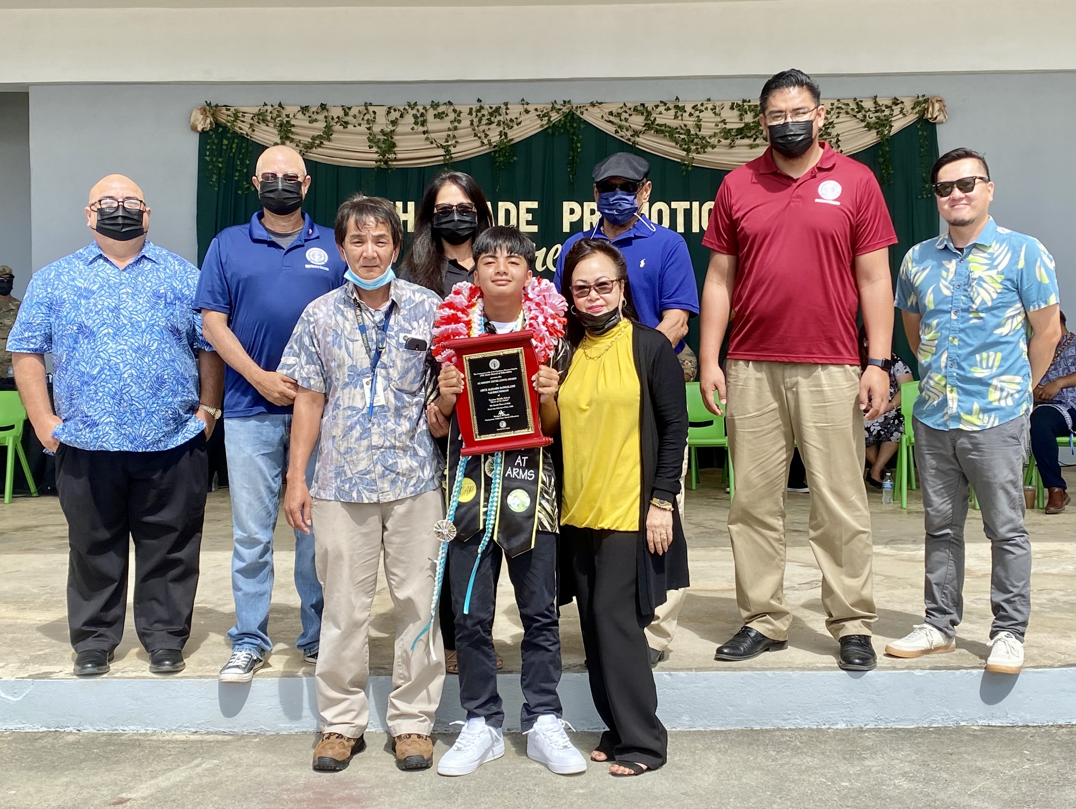 Class valedictorian and Board of Education Award recipient Arce Aligado Sangalang poses for a photo with his father, Cesar Sangalang, godmother Arlene Silva, BOE Chairman Gregory Pat Borja, Vice Chairman Antonio L. Borja, Secretary/Treasurer Maisie B. Tenorio Board Member Herman Atalig, Principal James Sablan and Vice Principal Reo Arriola.