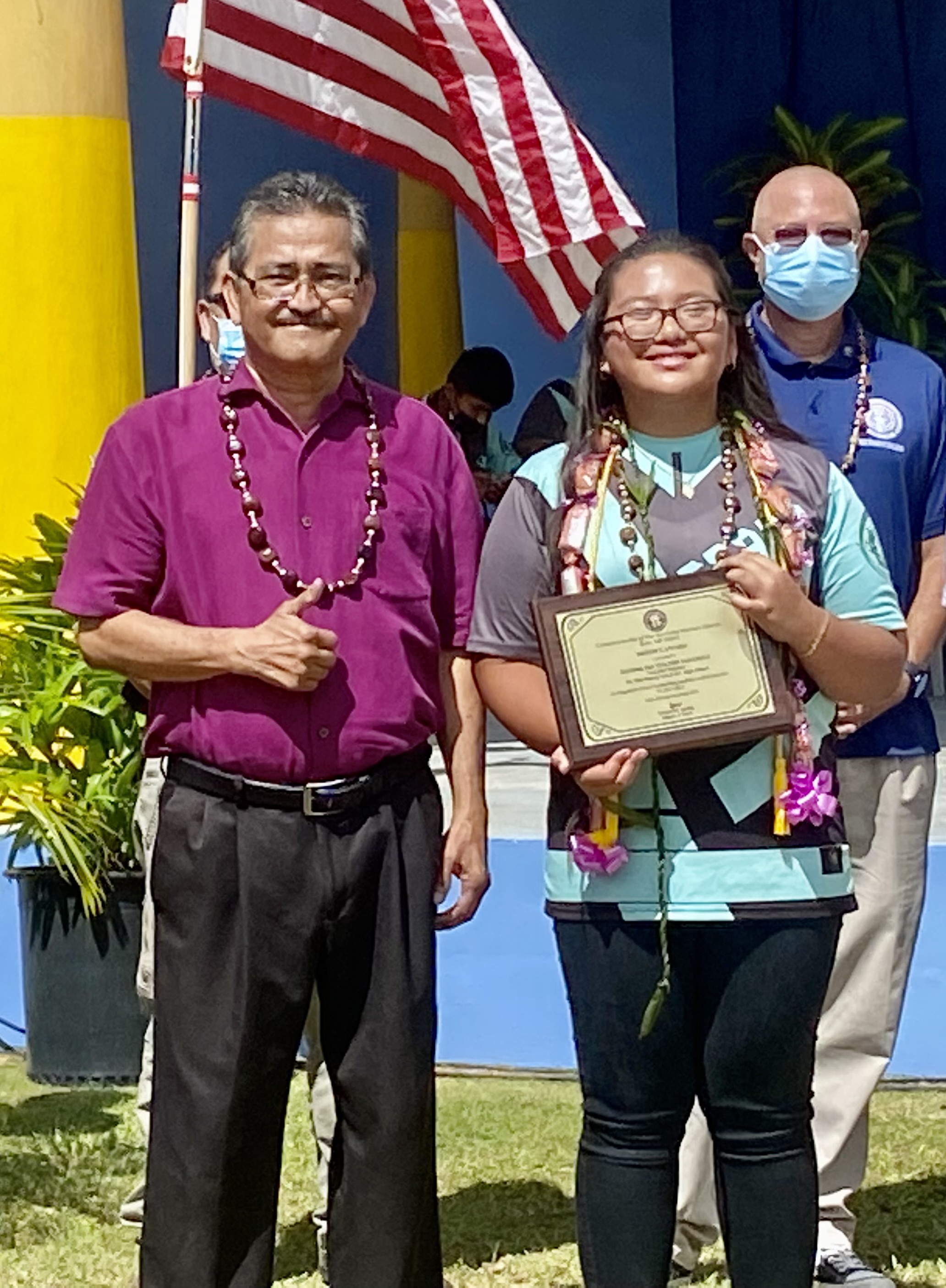 Junior high school valedictorian Rianna Isa Tuazon Barcinas receives the Mayor’s Award from Rota Mayor Efraim Atalig.