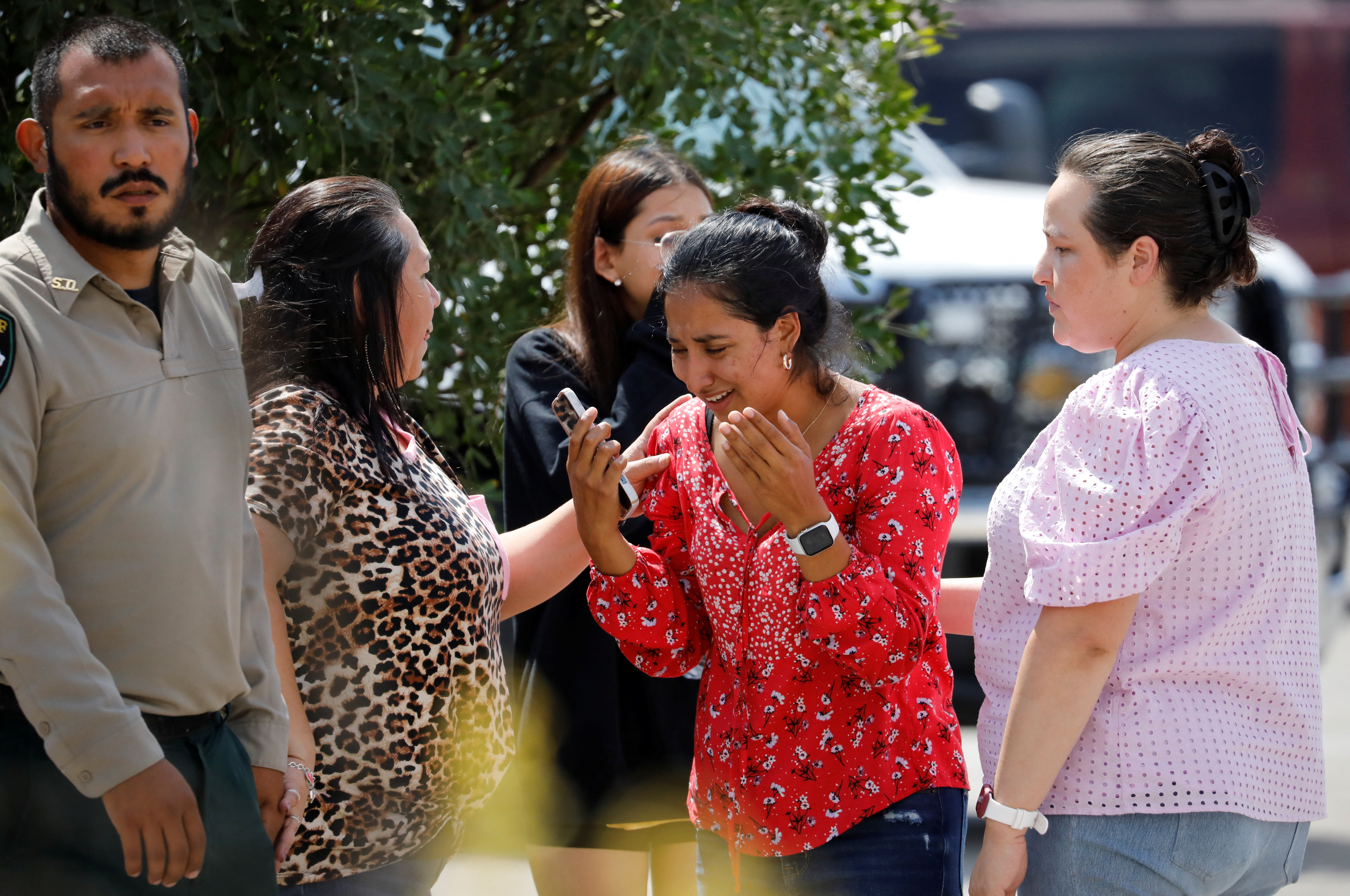 A woman reacts outside the SSgt. Willie de Leon Civic Center, where students had been transported from Robb Elementary School after a shooting, in Uvalde, Texas, May 24, 2022.
