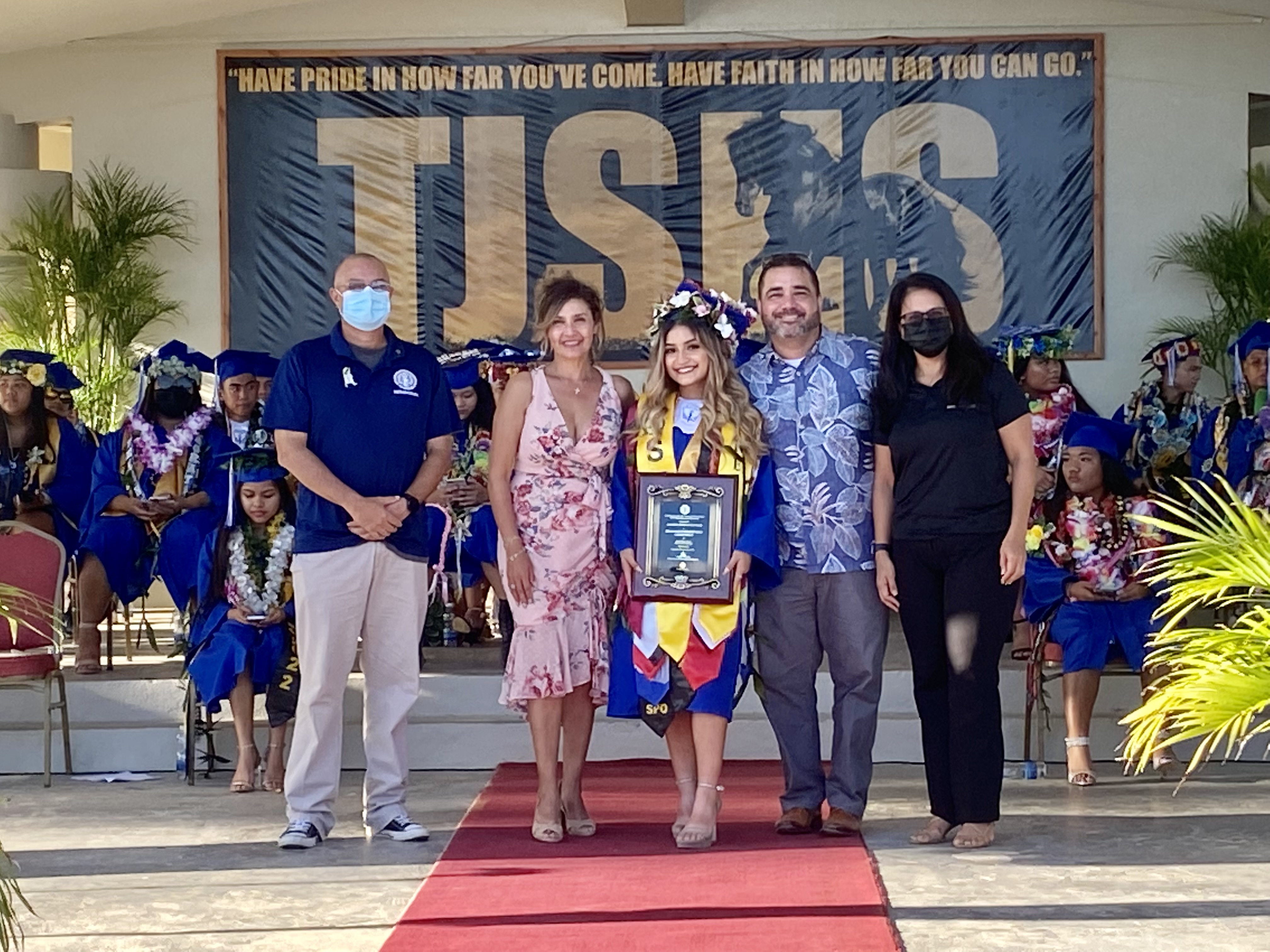 Tinian High School valedictorian Isa Ha’ani Gutierrez Long receives the Board of Education Award from BOE Chairman Gregory Pat Borja and Secretary/Treasurer Maisie B. Tenorio. Also in photo are parents Arley and Philip Mendiola-Long.
