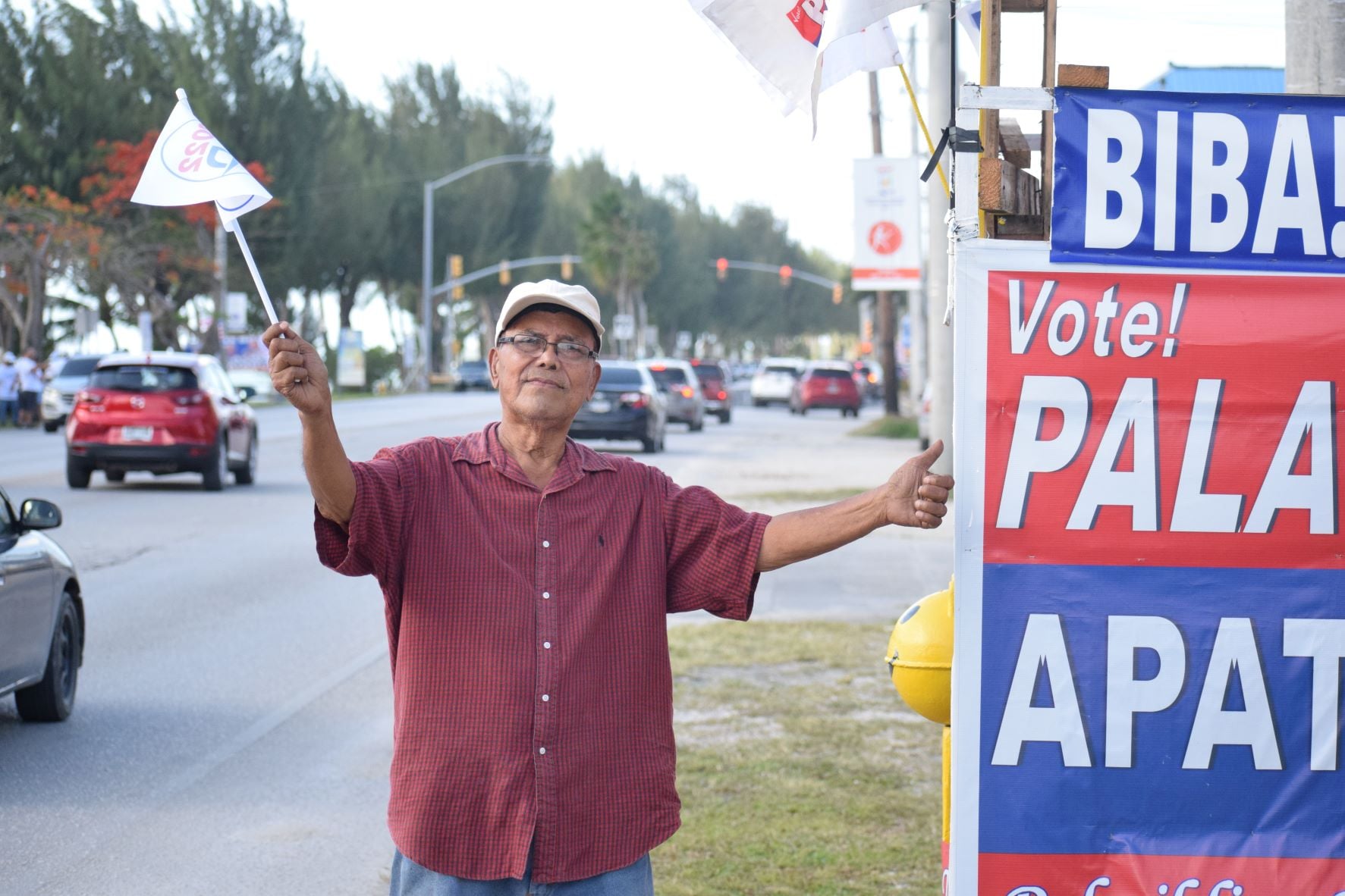 Former Marianas District Legislature and Congress of Micronesia member Felipe Q. Atalig joins the road-side waving activity of independent gubernatorial candidate Lt. Gov. Arnold I. Palacios and running mate Saipan Mayor David M. Apatang on Friday at the San Jose traffic light intersection.