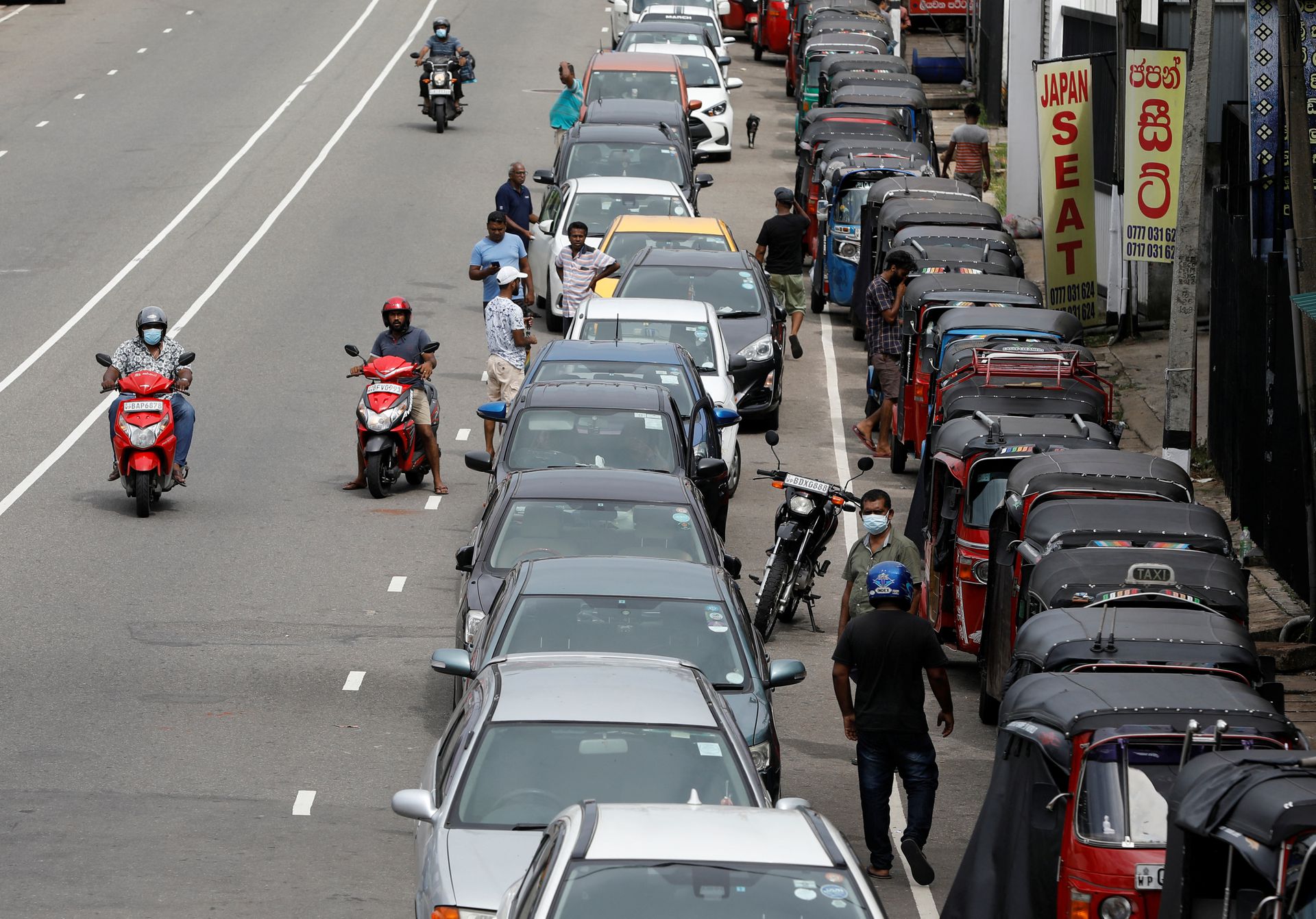 Drivers in their vehicles wait in a queue to buy petrol at a fuel station, amid the country's economic crisis in Colombo, Sri Lanka, May 16, 2022.