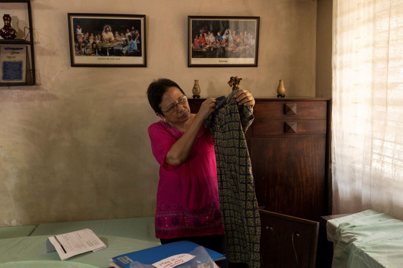 Cristina Bawagan, 67, shows the dress she wore when she was arrested, tortured and sexually abused by soldiers during the martial law regime of late Philippine dictator Ferdinand Marcos in her home at Quezon City, Metro Manila on April 22, 2022.